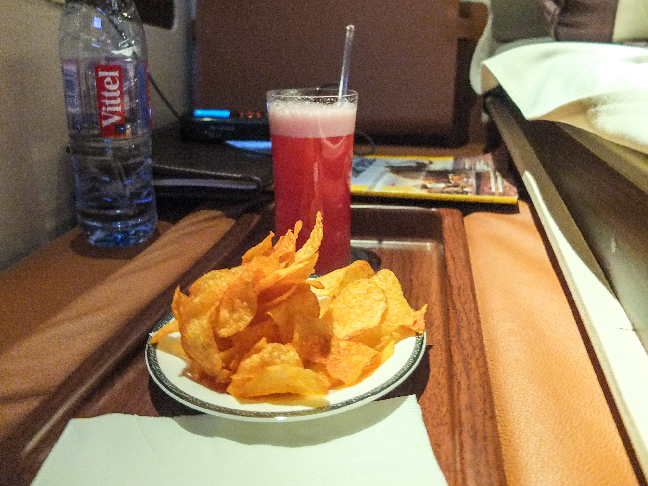 a plate of chips and a drink on a tray