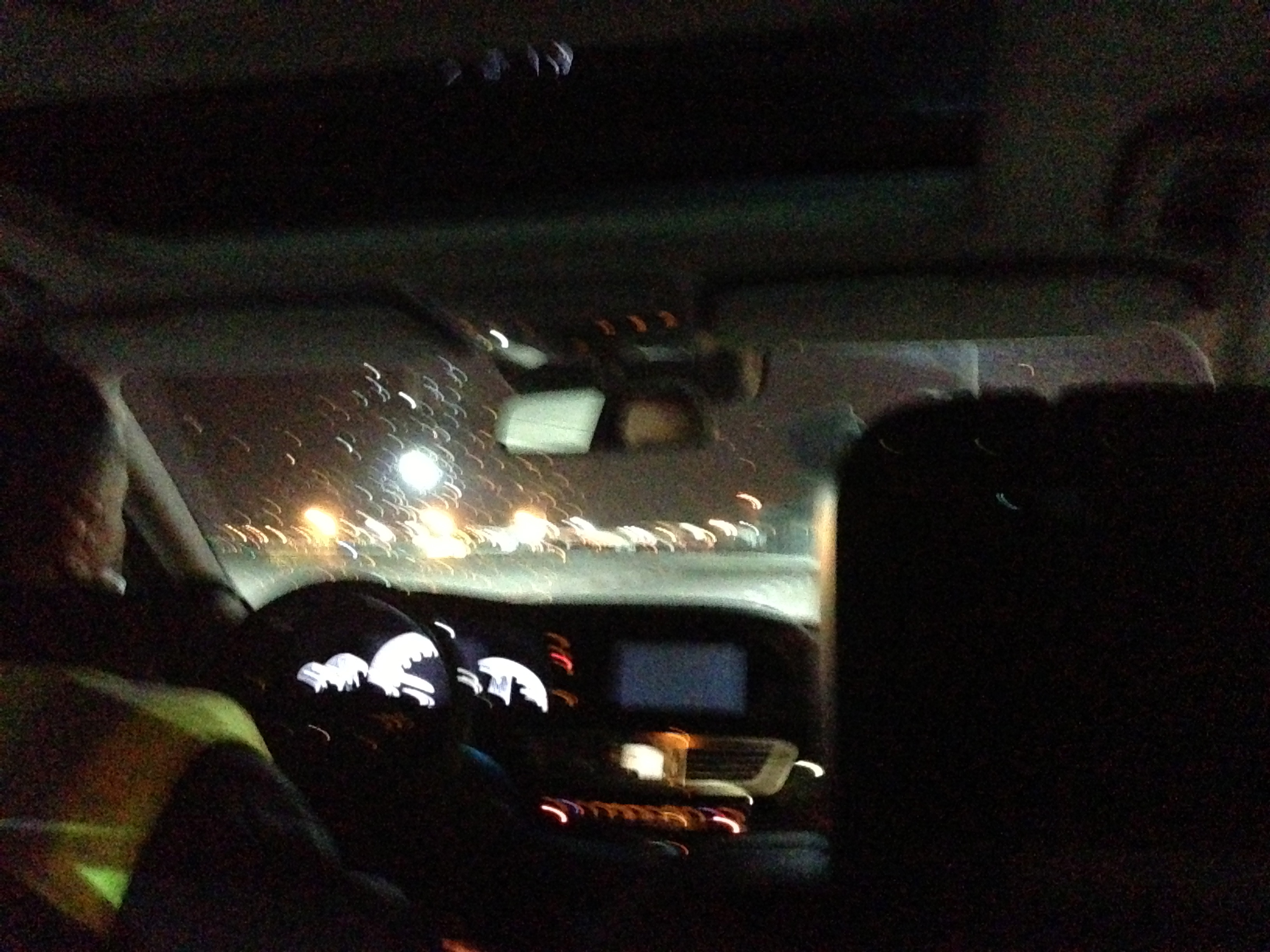 a view from inside of a car at night