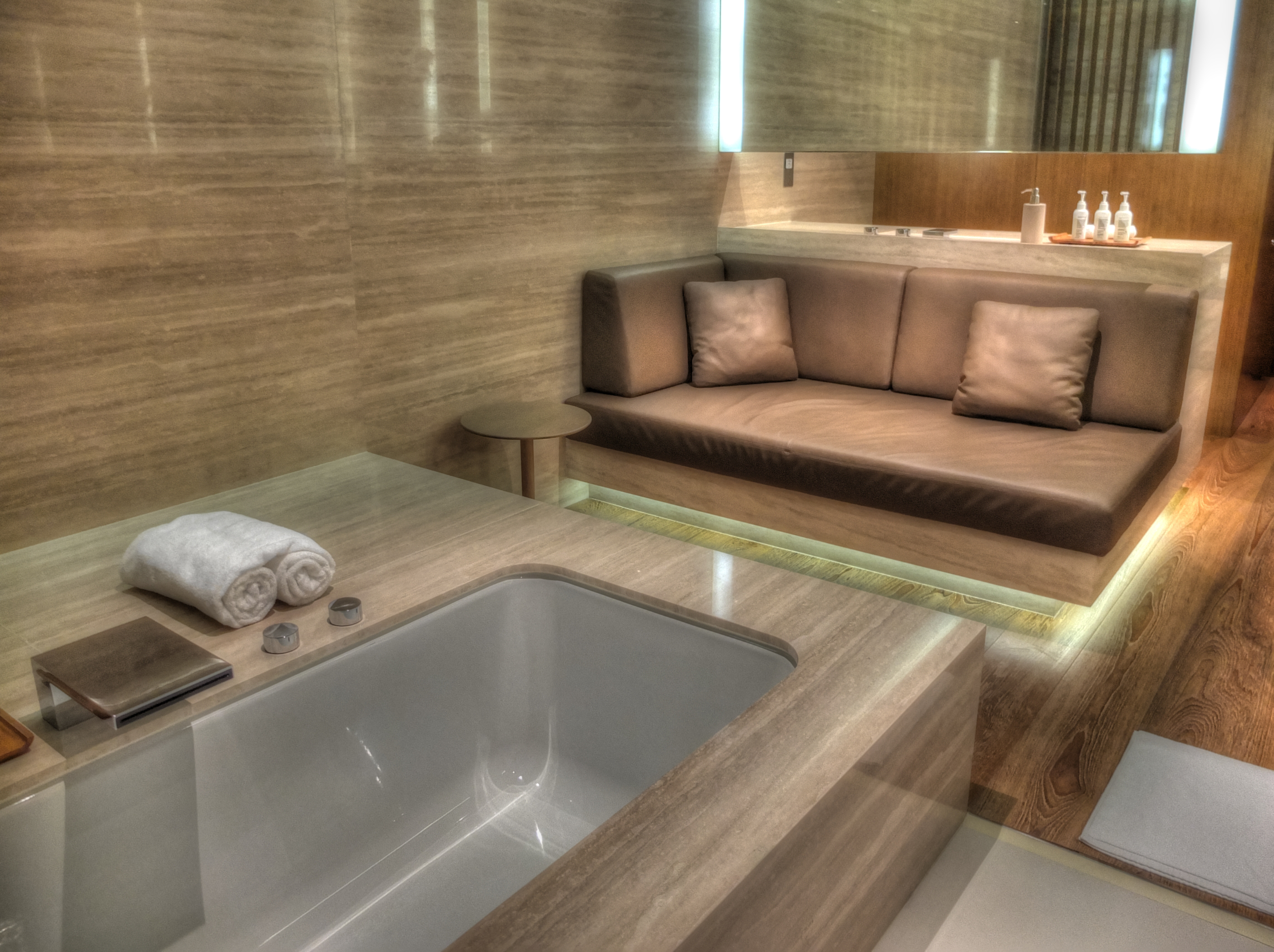 a bathroom with a couch and bathtub