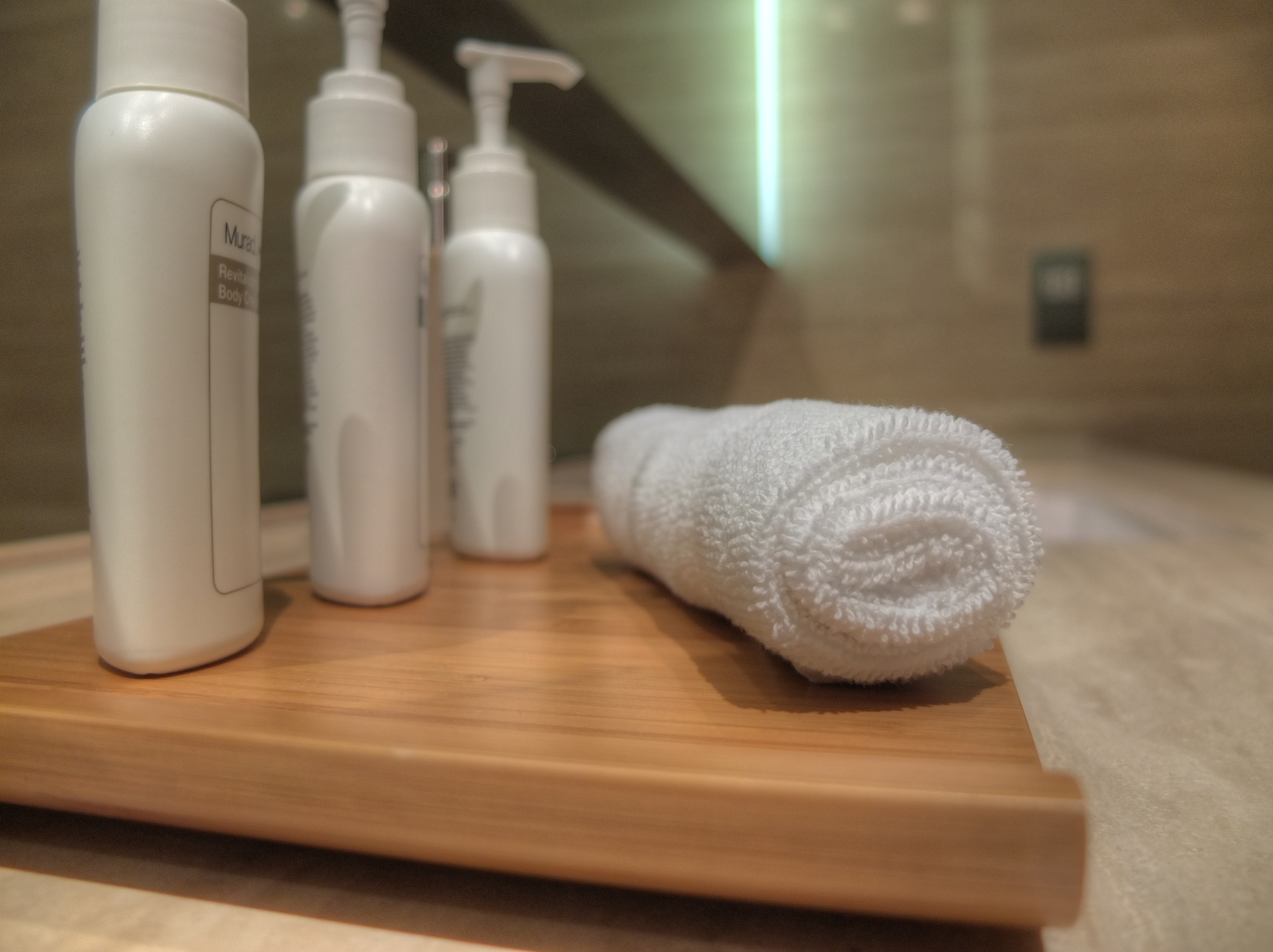 a white towel and bottles on a wooden surface