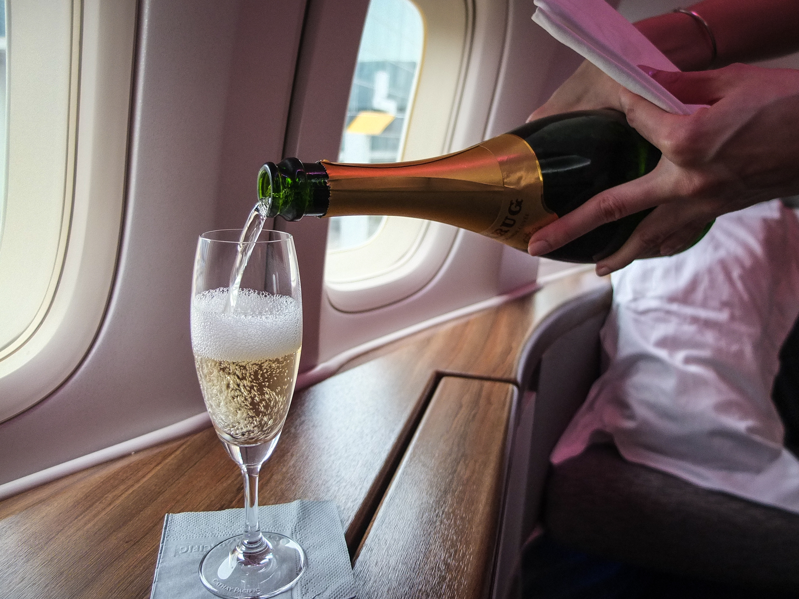a person pouring champagne into a glass