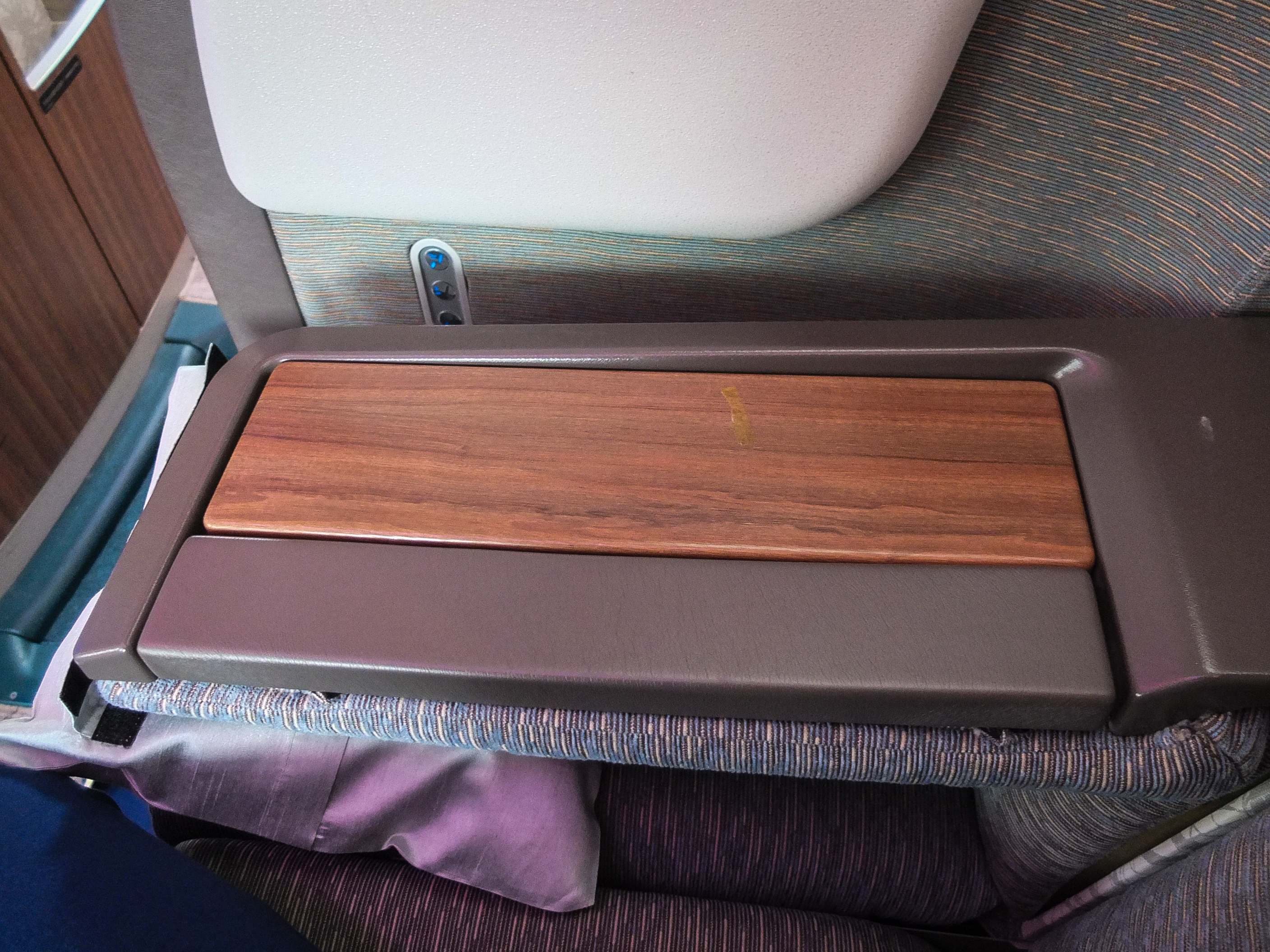 a wooden arm rest on a seat