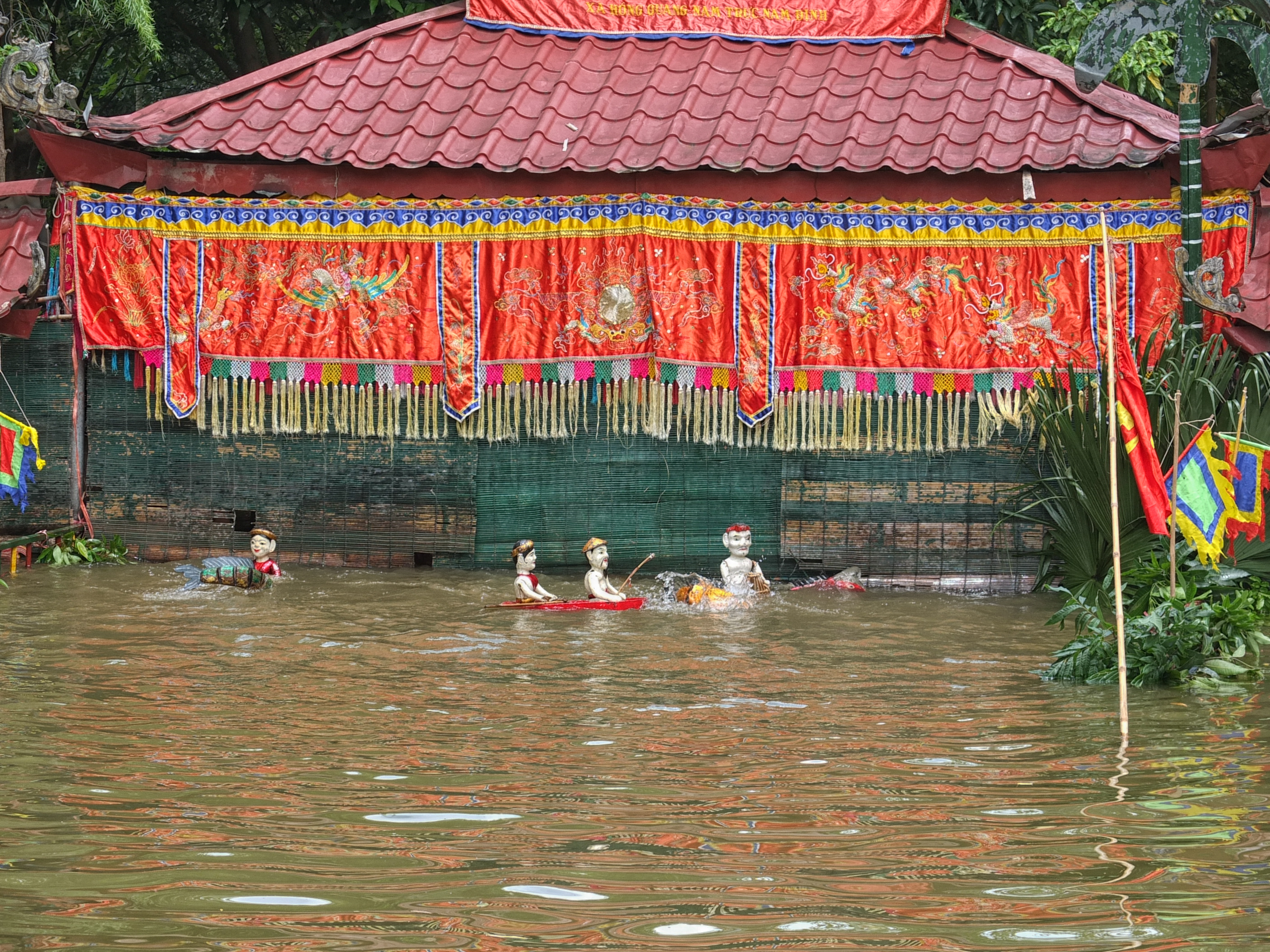 a group of statues in a flooded area