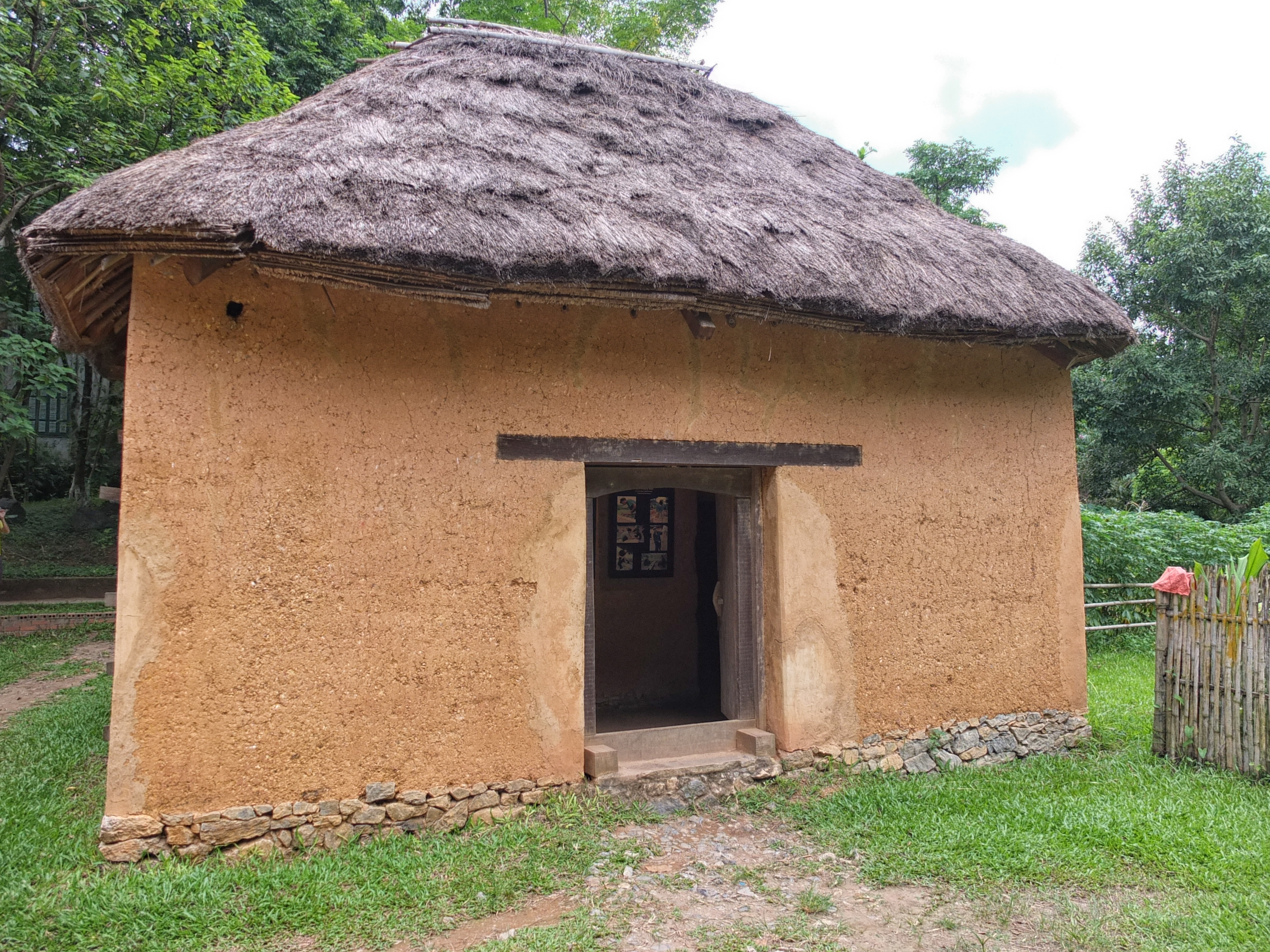 a small building with a straw roof