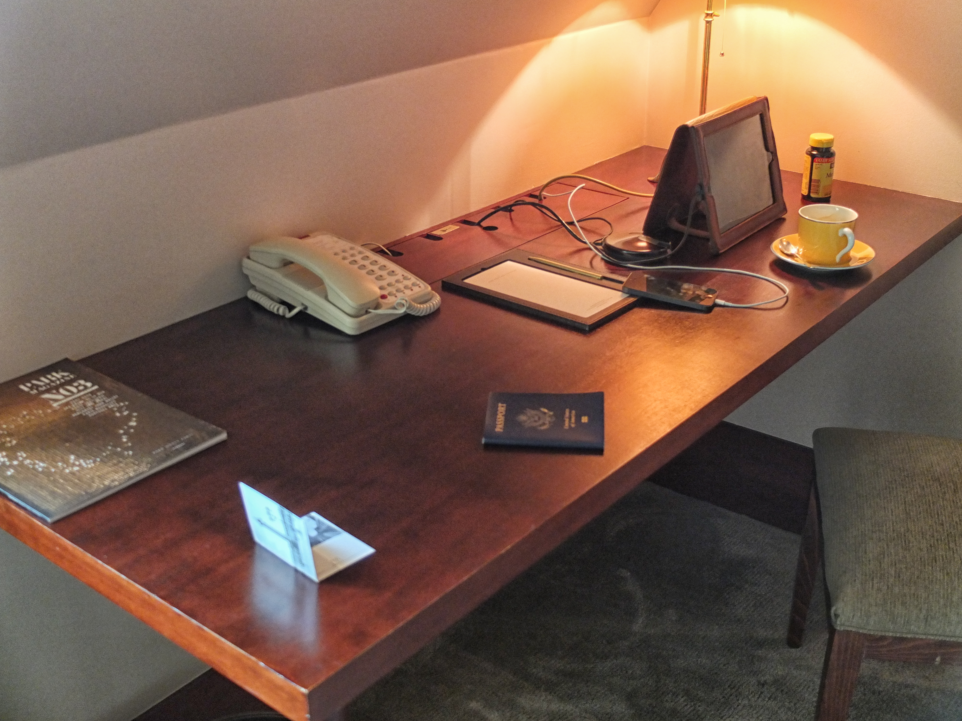 a desk with a phone and a tablet