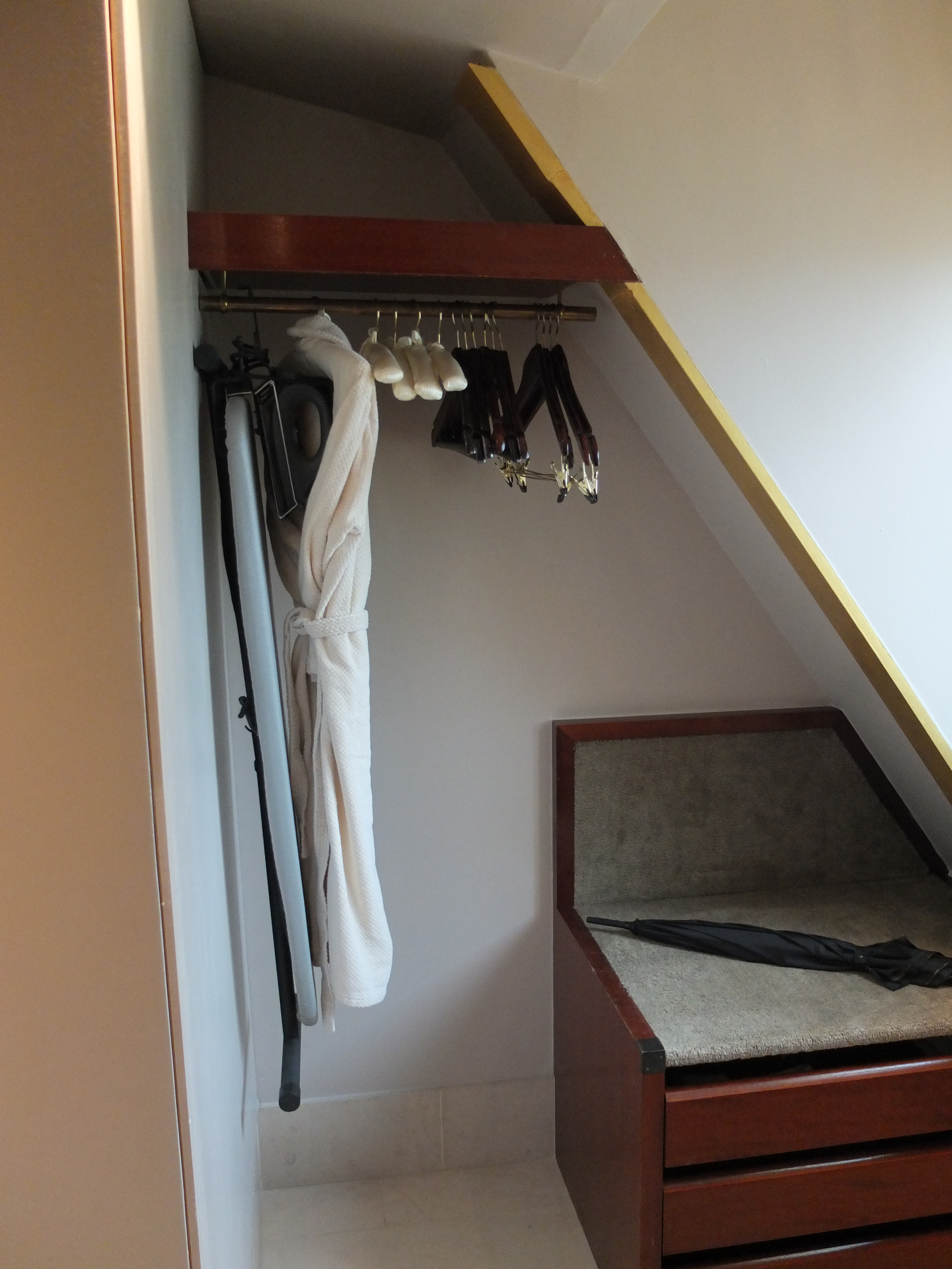 a closet with clothes on a swinger