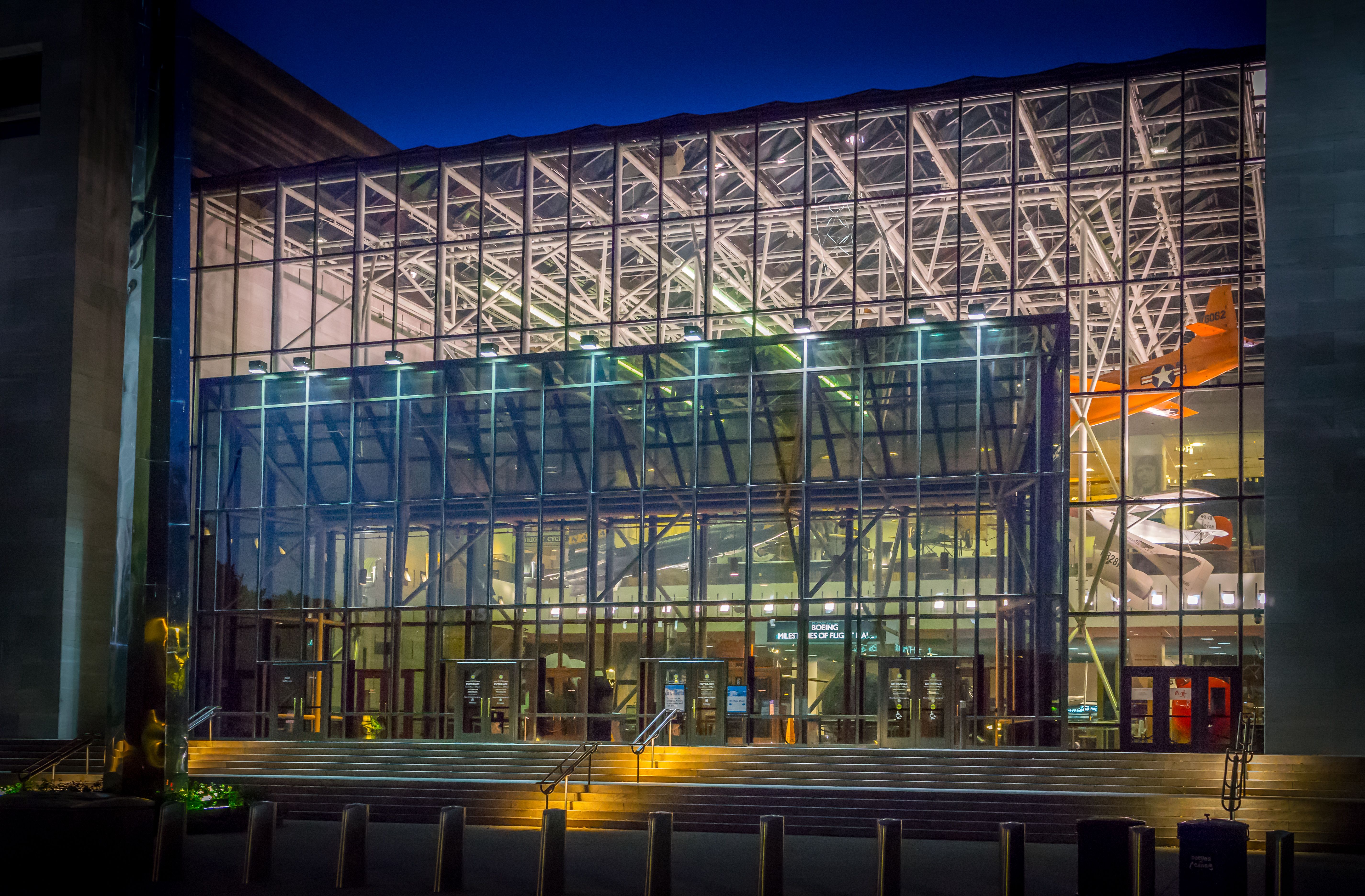 a building with glass walls and lights