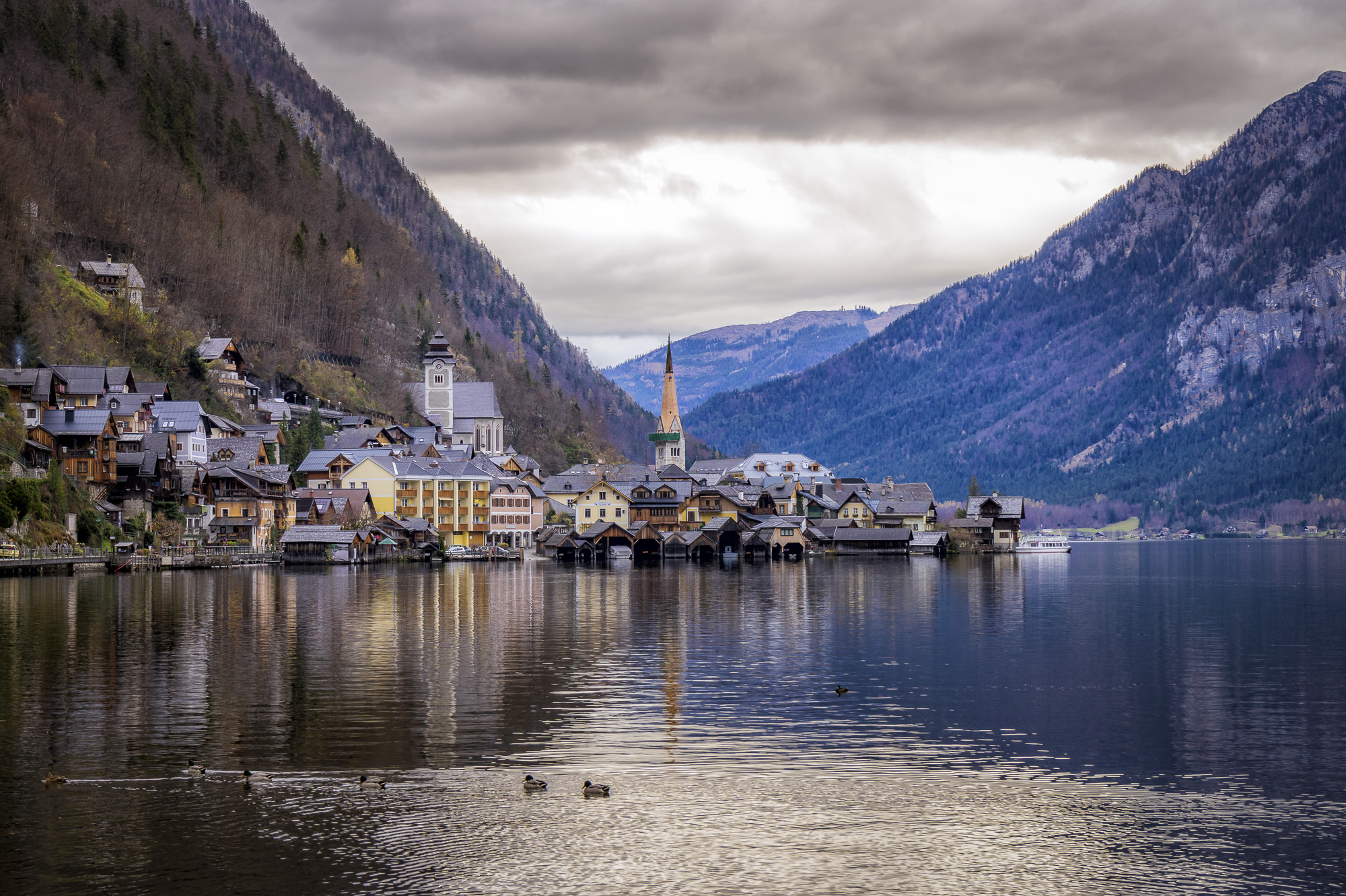 a town on the water with Hallstatt in the background