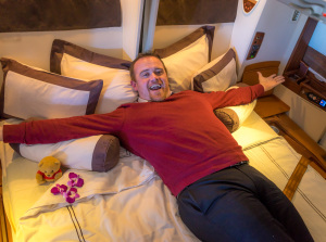 a man lying on a bed with his arms out