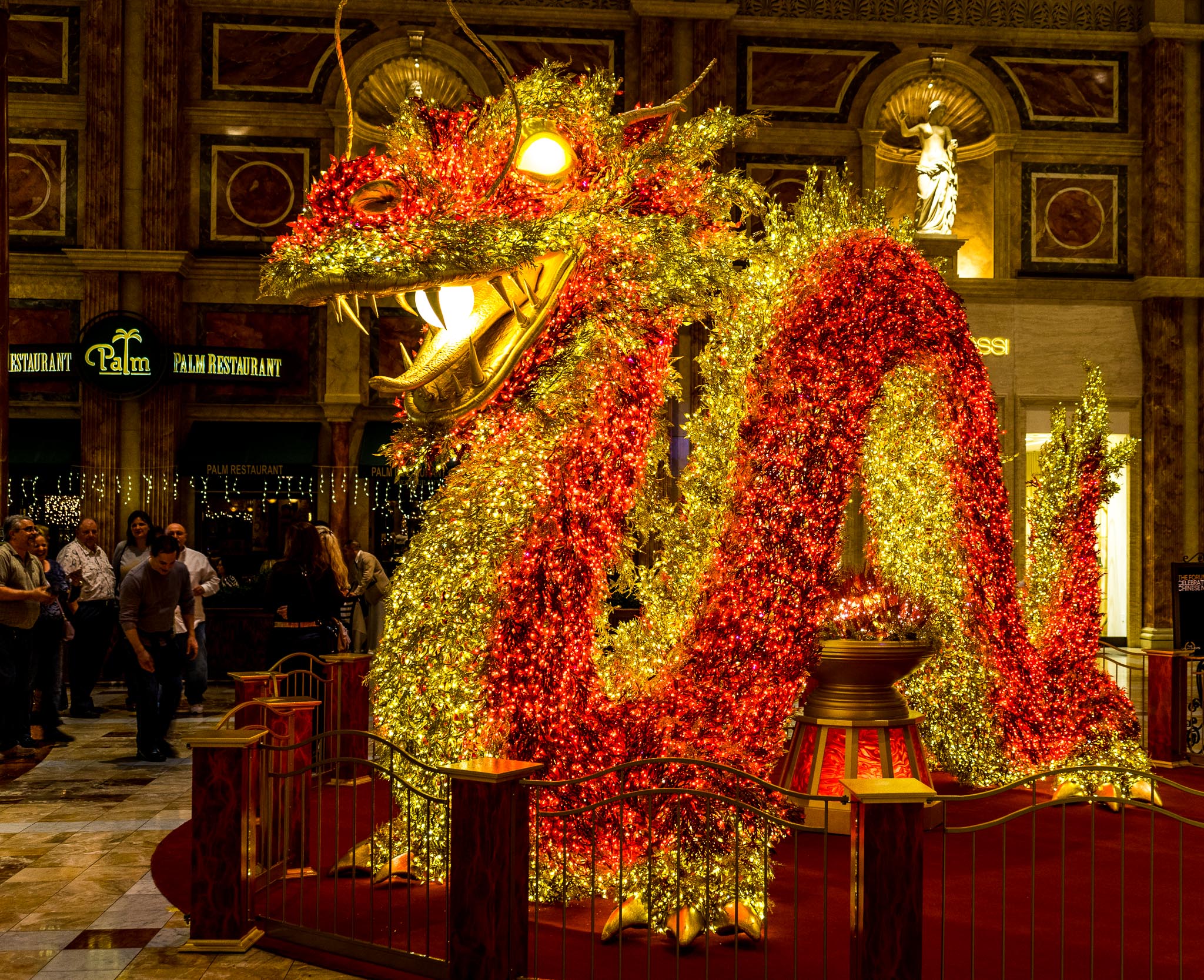 a large red and yellow dragon statue