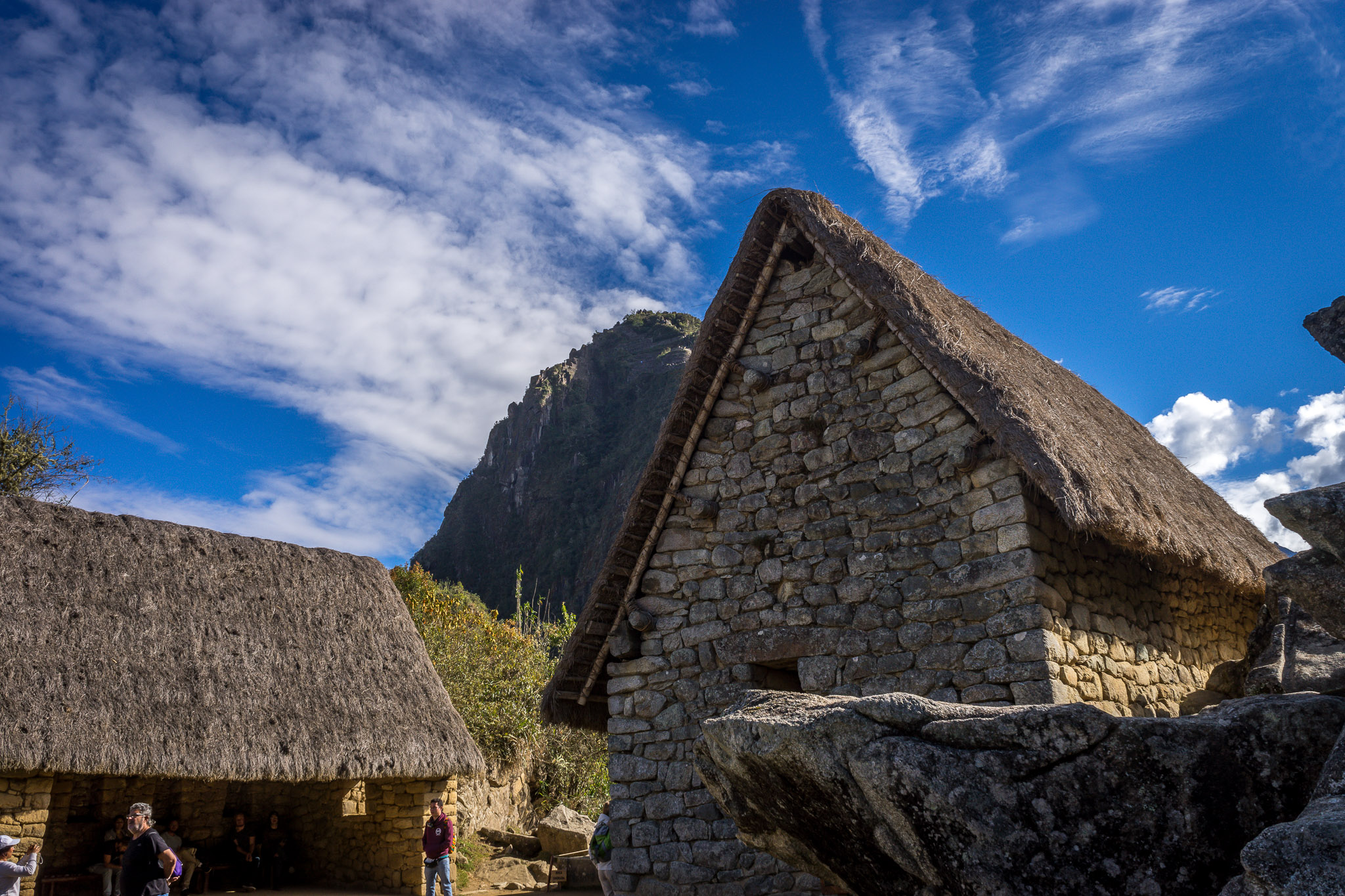 a stone buildings with a thatched roof