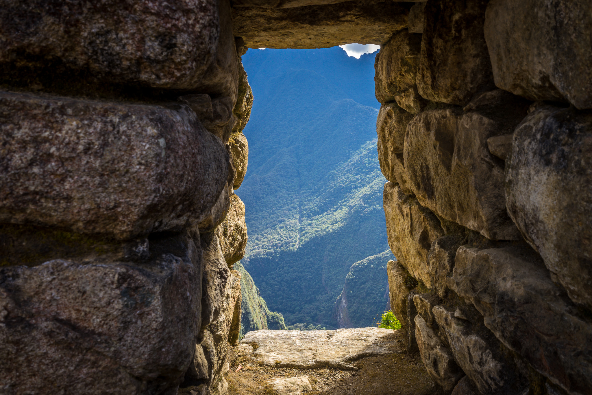 a stone doorway with a view of the mountains