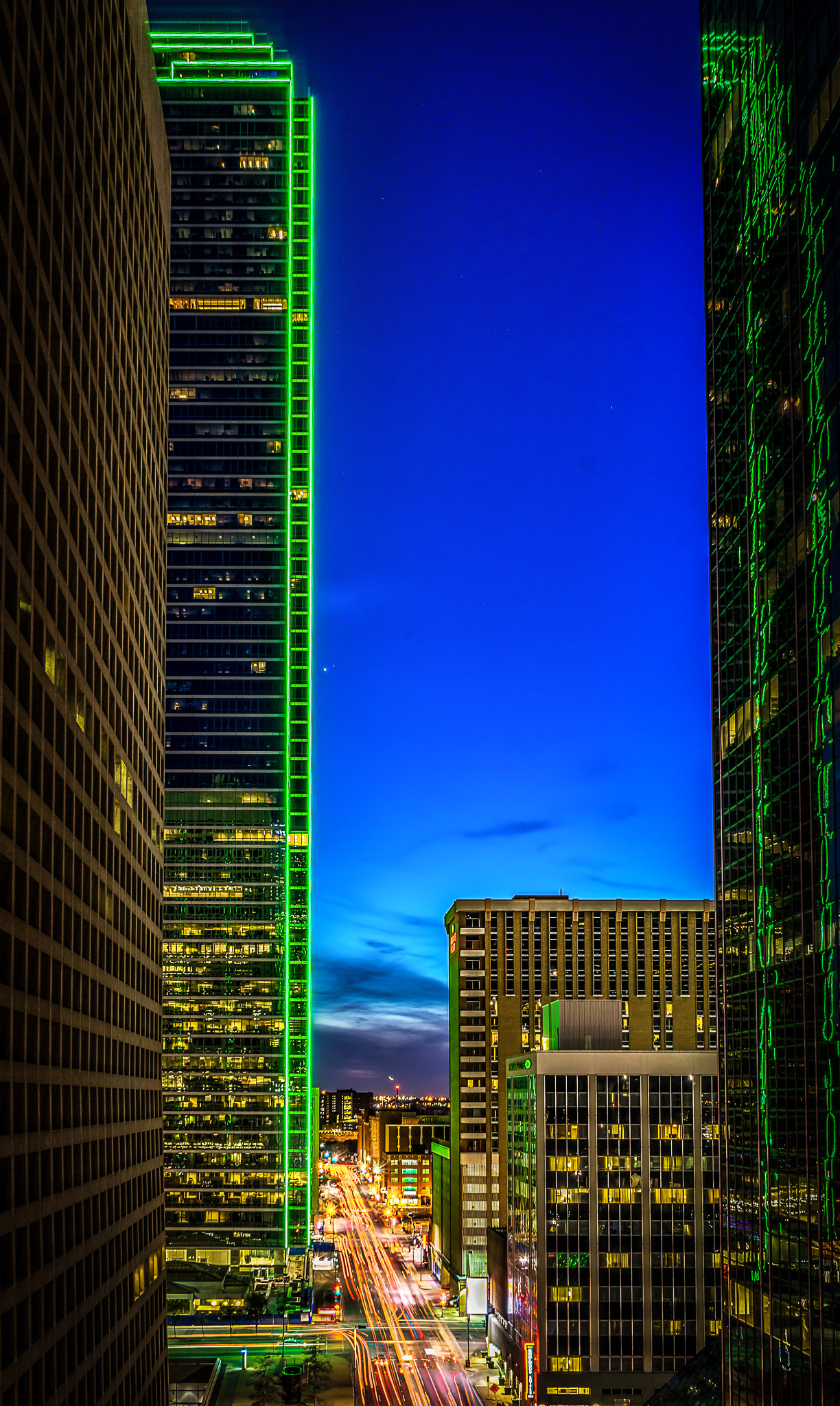 a tall buildings with green lights