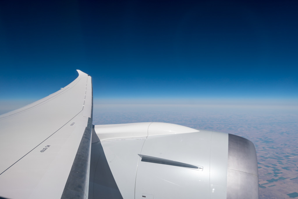 an airplane wing and a blue sky