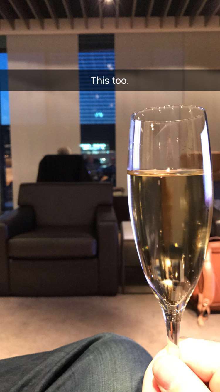 a glass of champagne in front of a couch