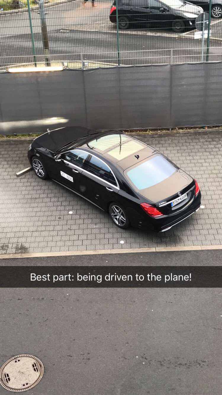 a black car parked on a brick road