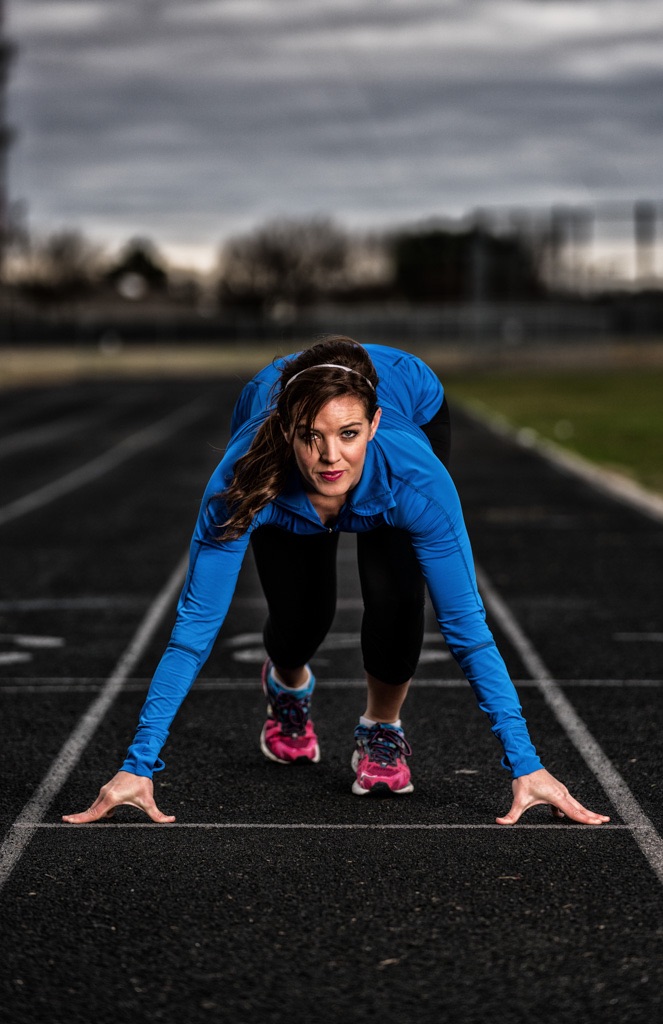 a woman in blue shirt on a track