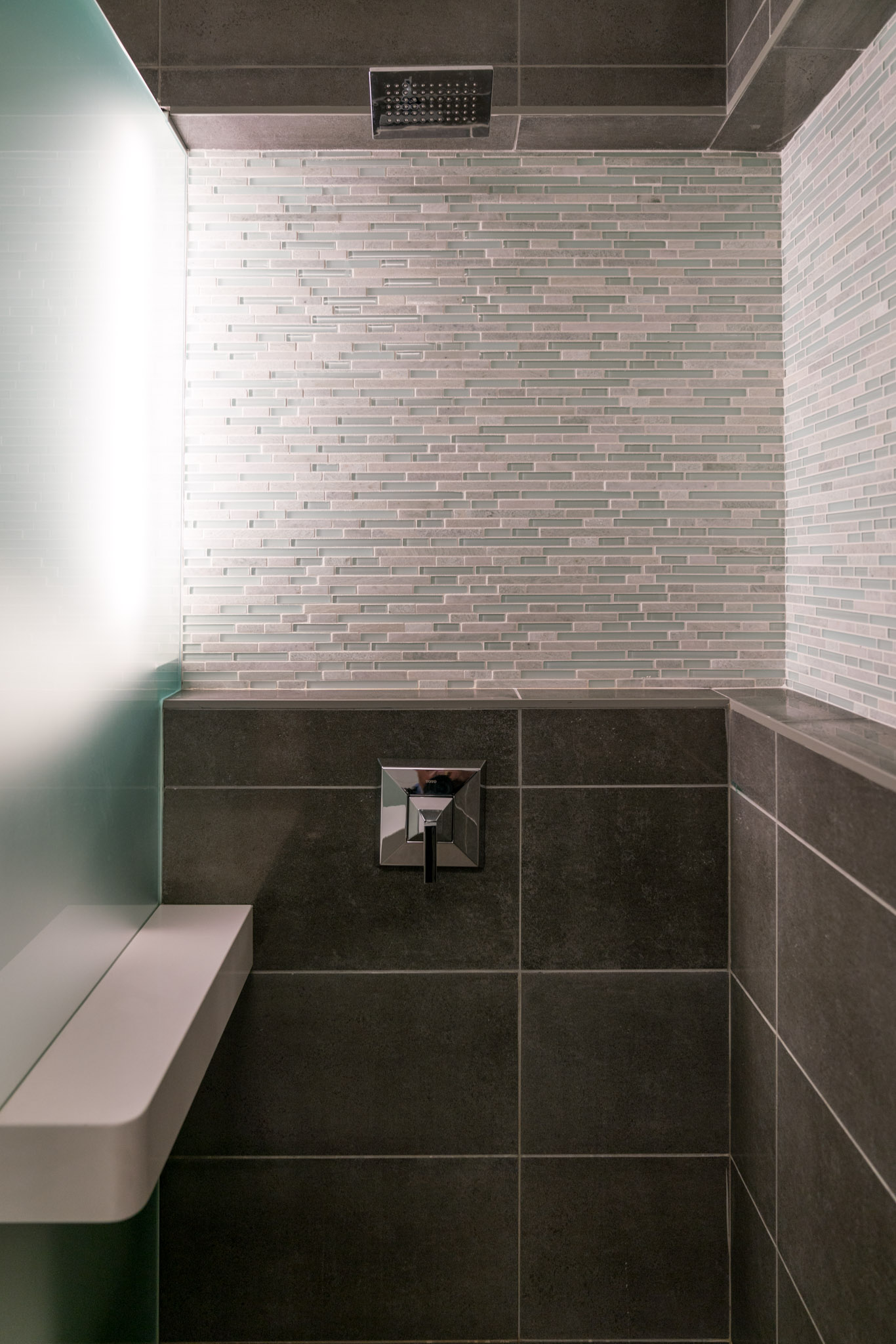 a bathroom with tile walls and a sink