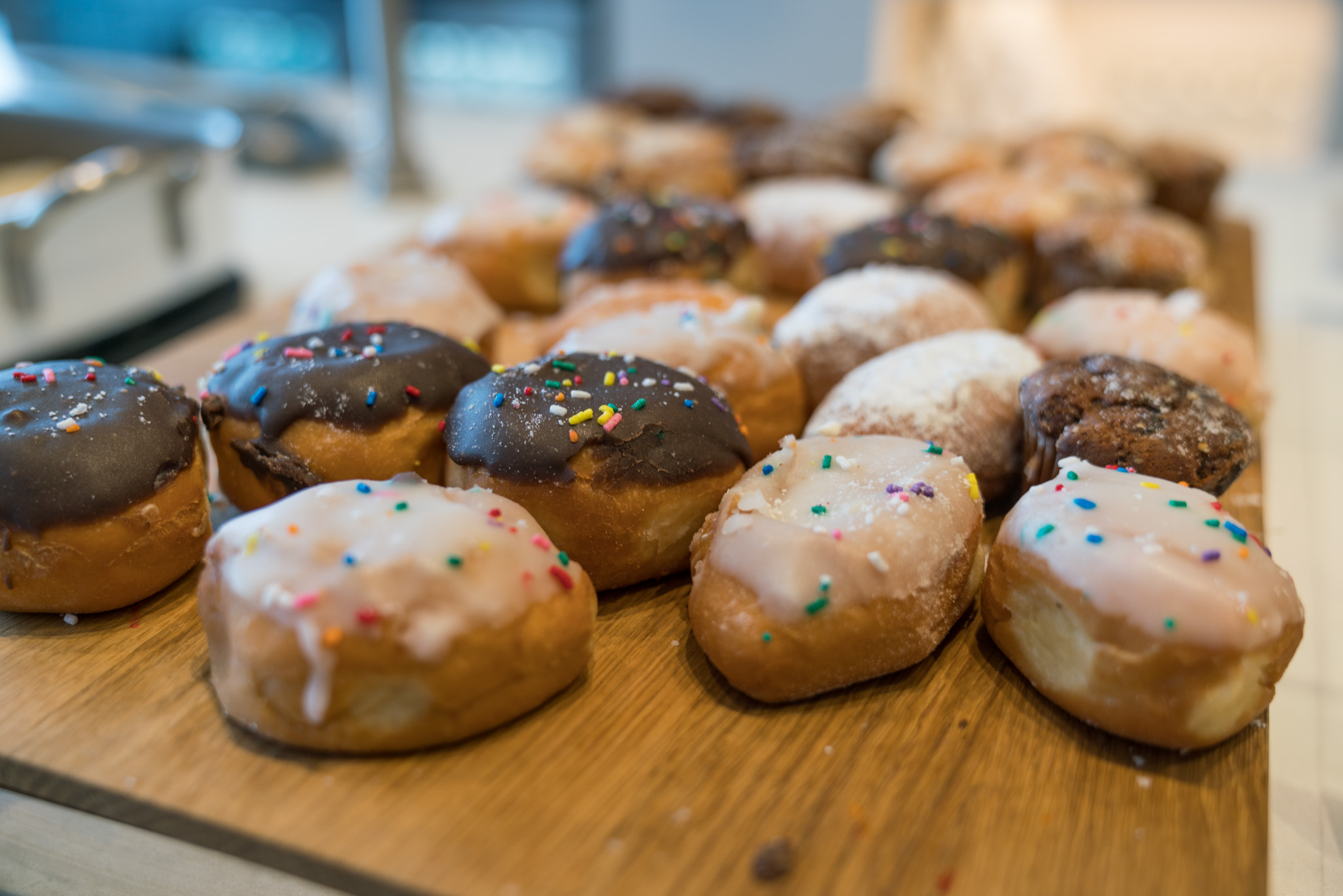a group of doughnuts on a wooden surface