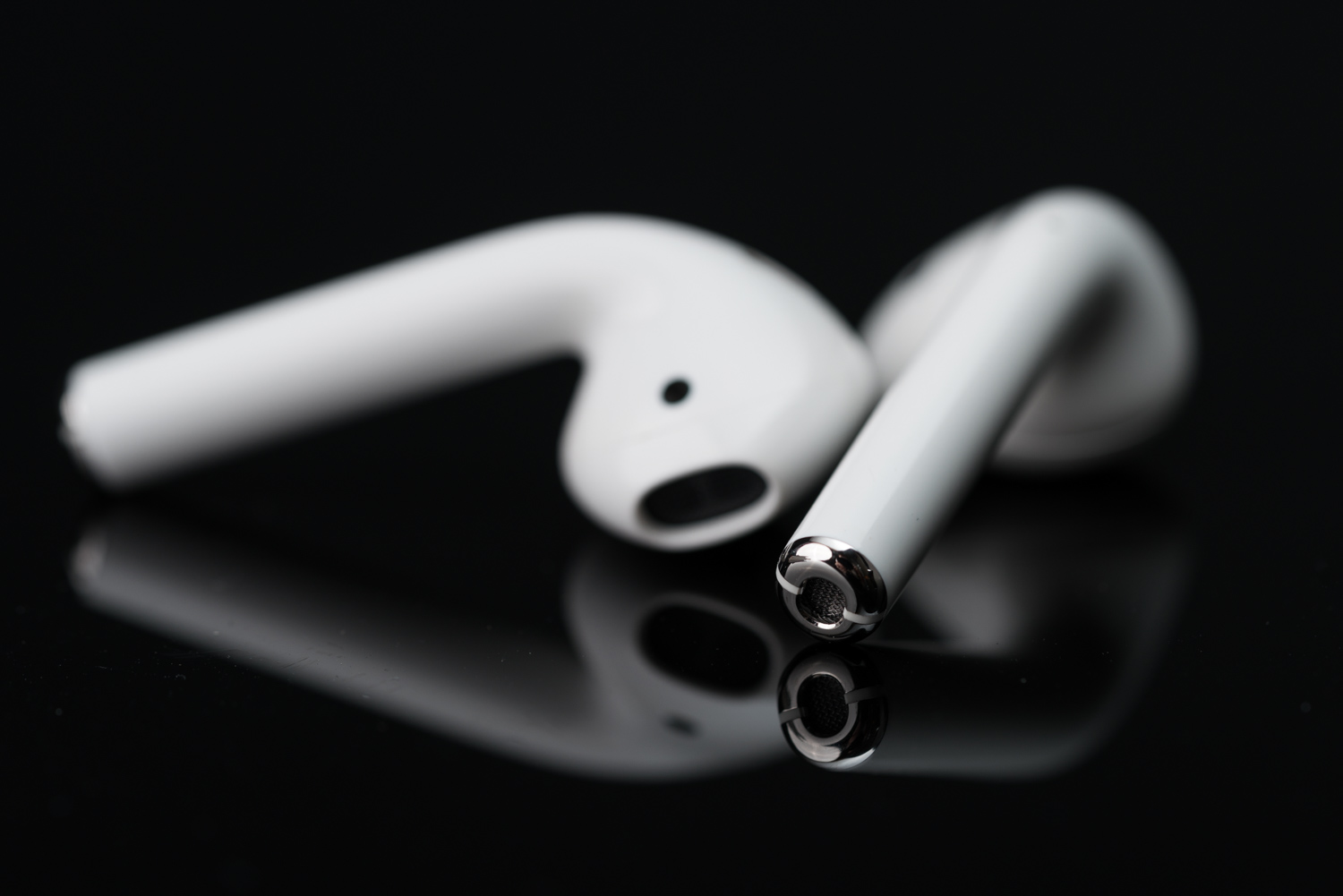 a white earbuds on a black surface