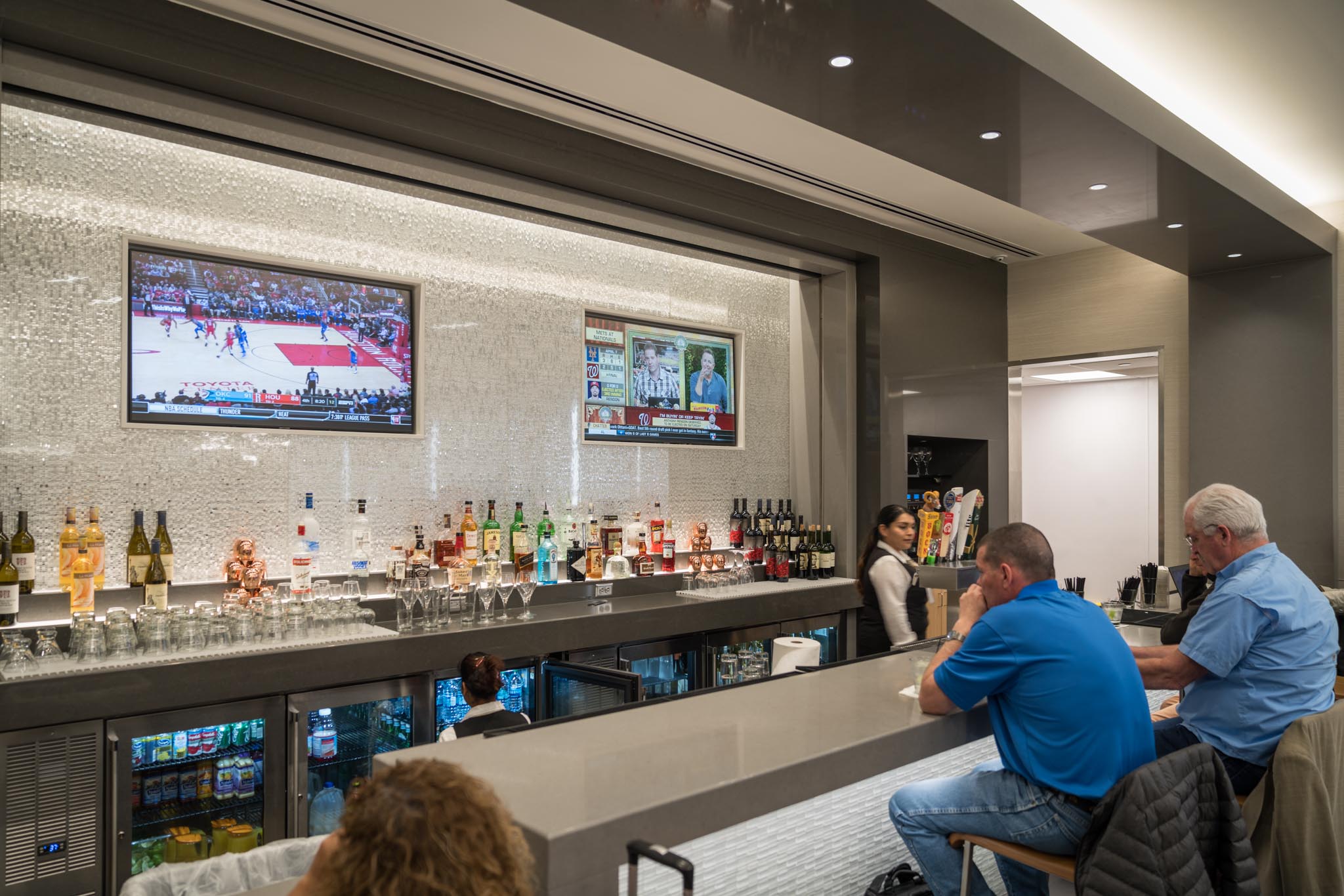 a bar with a television and drinks