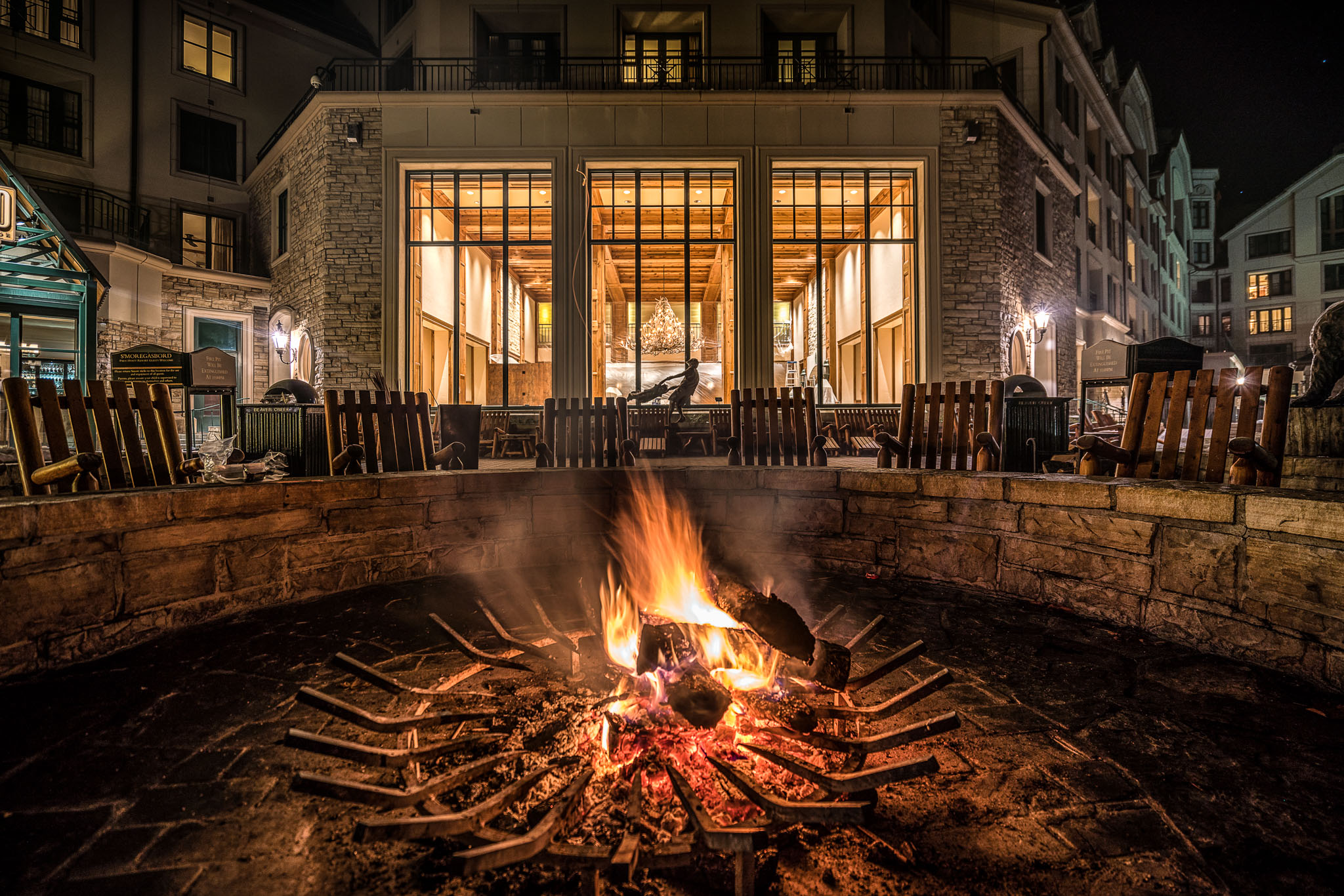 a fire pit with a large building in the background