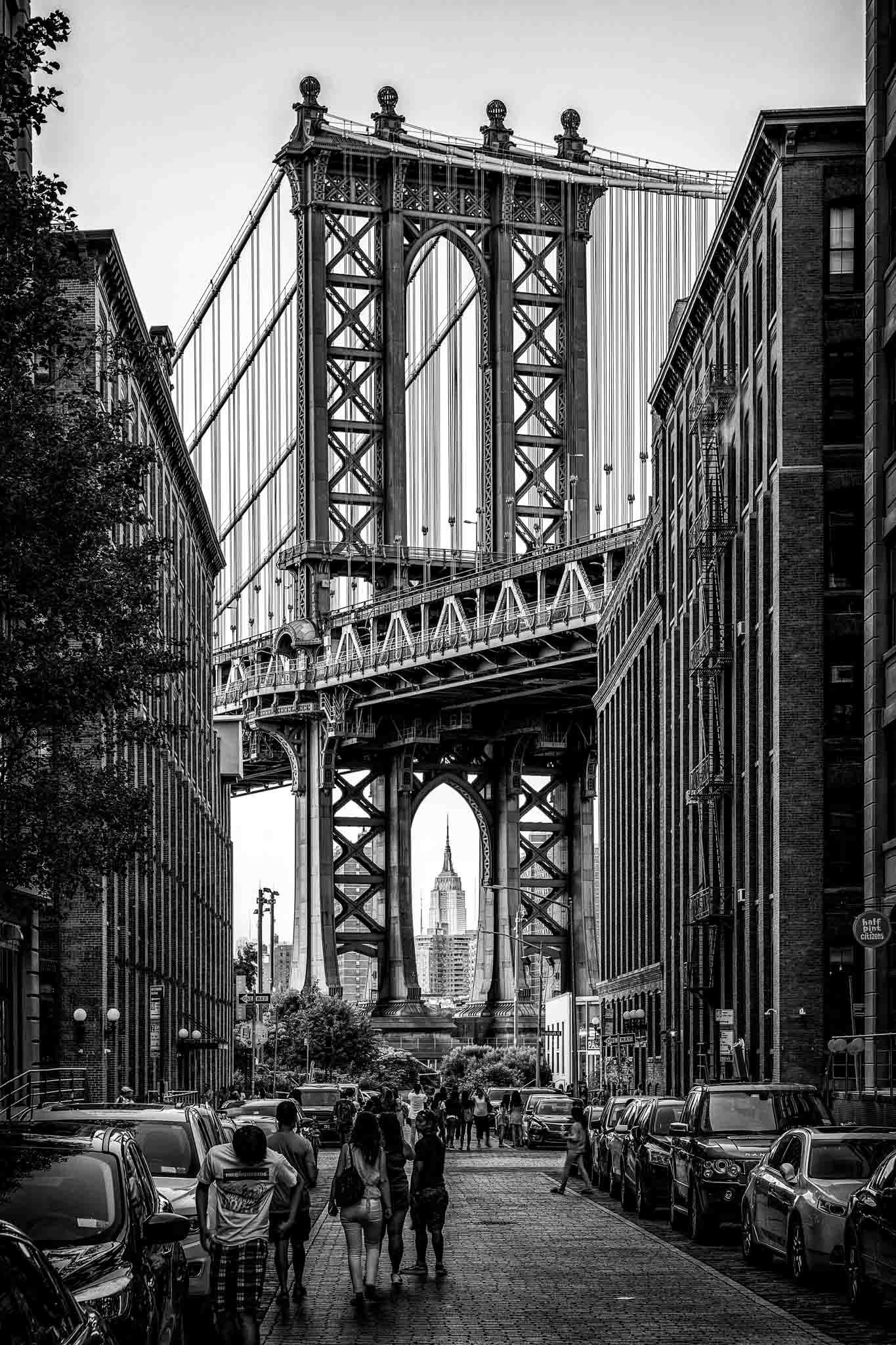 Manhattan Bridge with people walking on the street