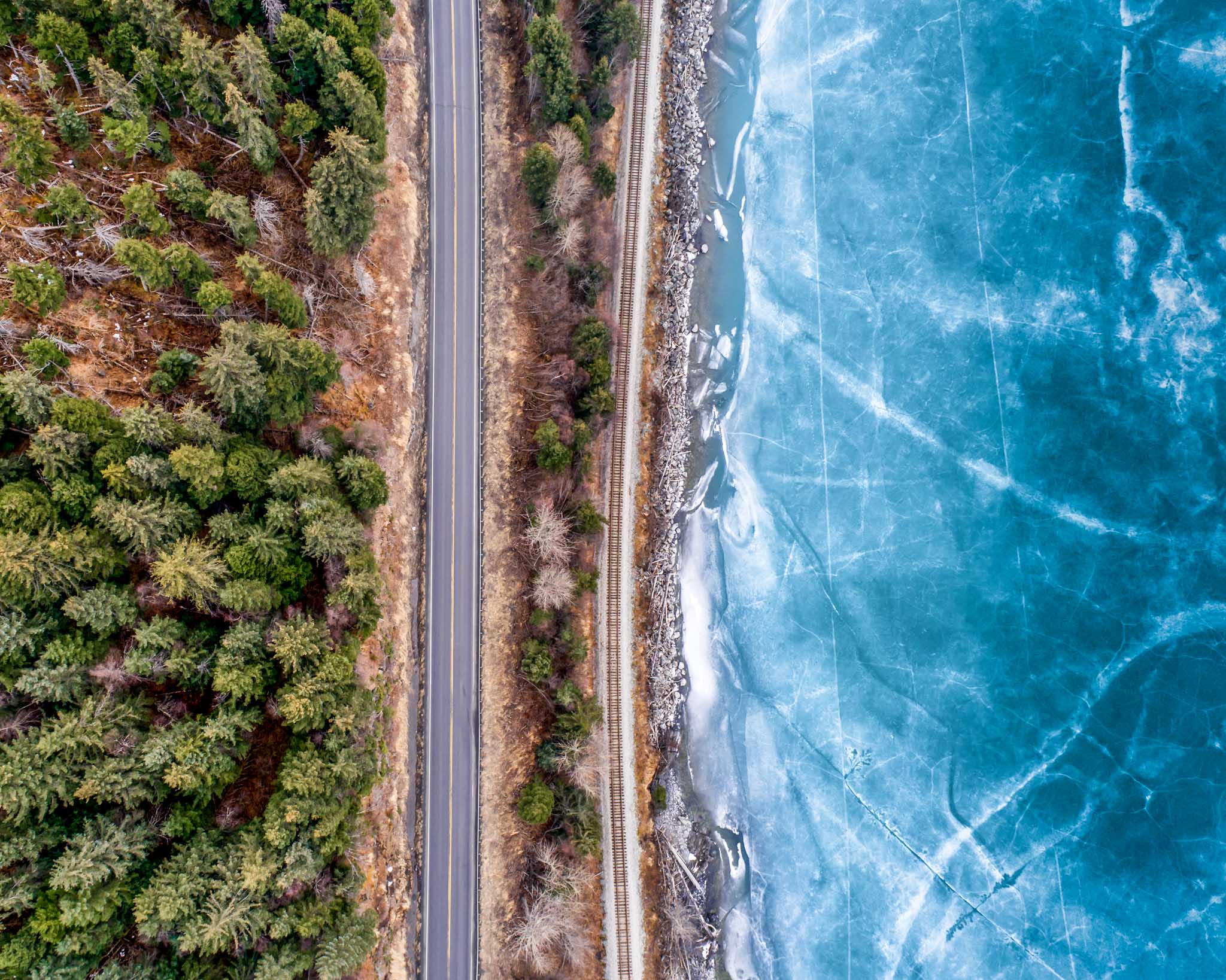a road next to a frozen lake