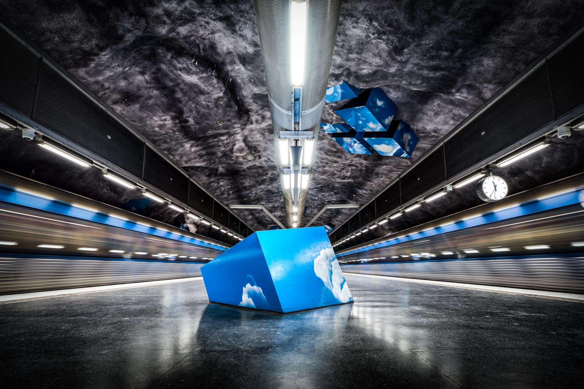 a blue cube in a subway station