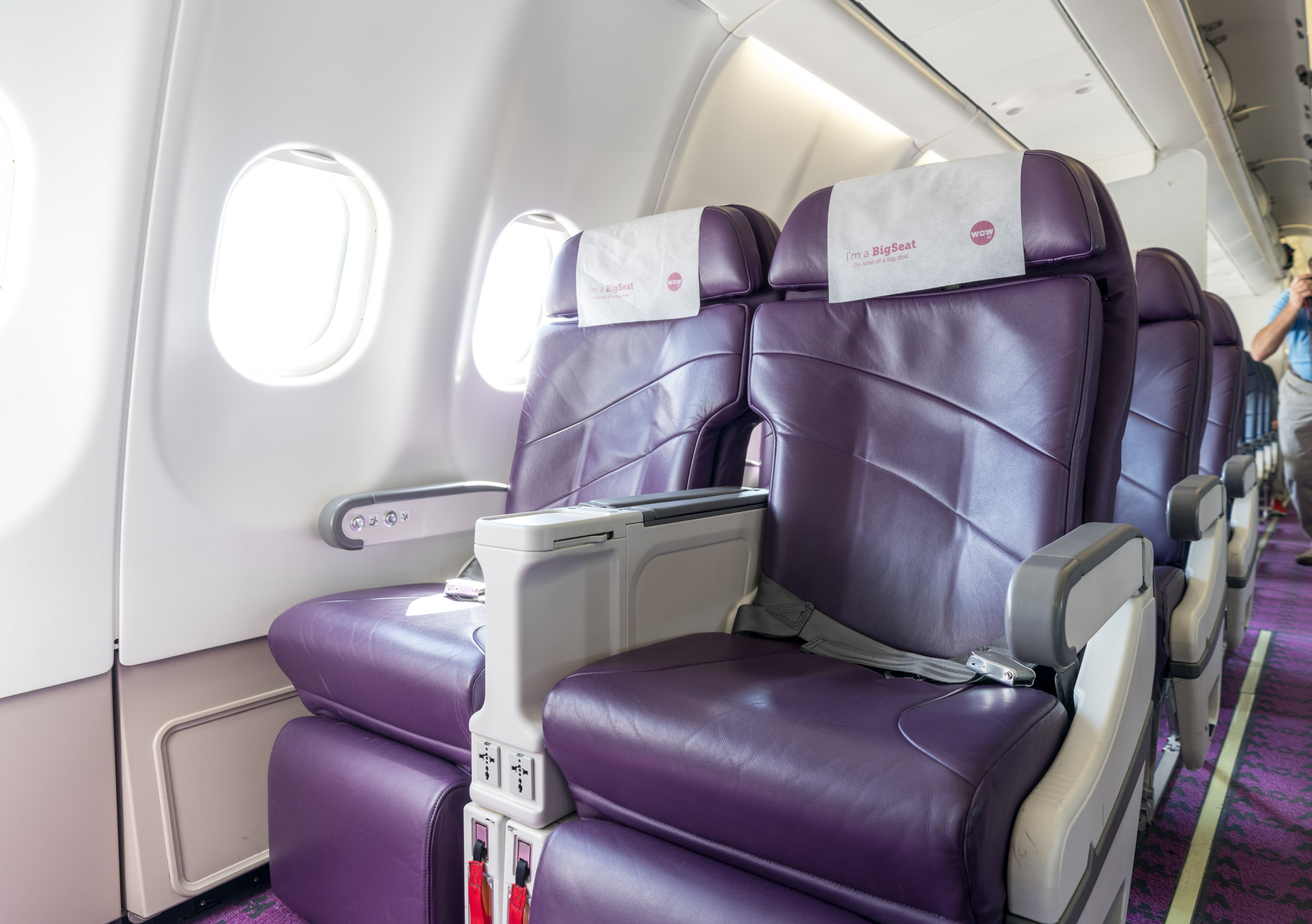 a purple leather seats in an airplane
