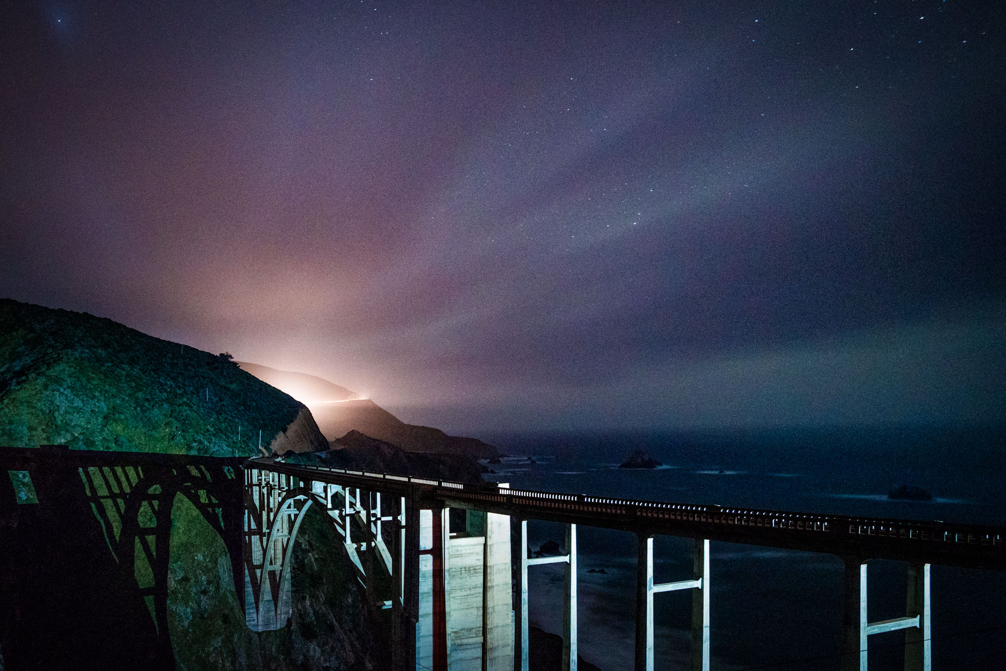 a bridge over a cliff at night