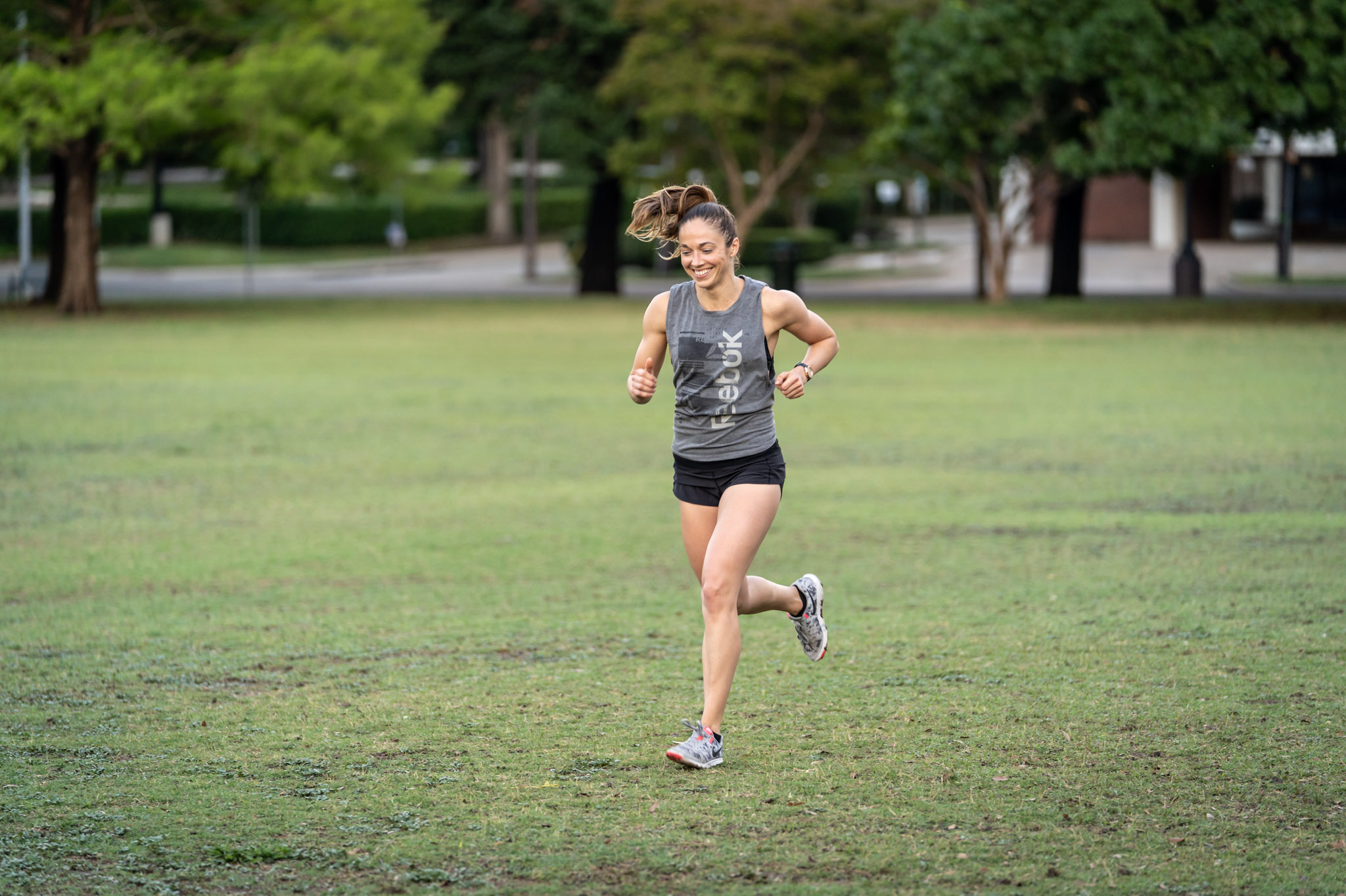 a woman running on a grass field