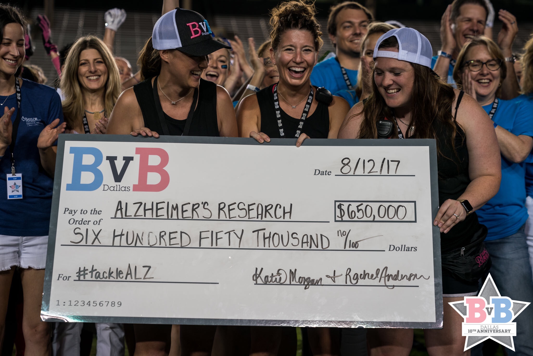 a group of people holding a large check