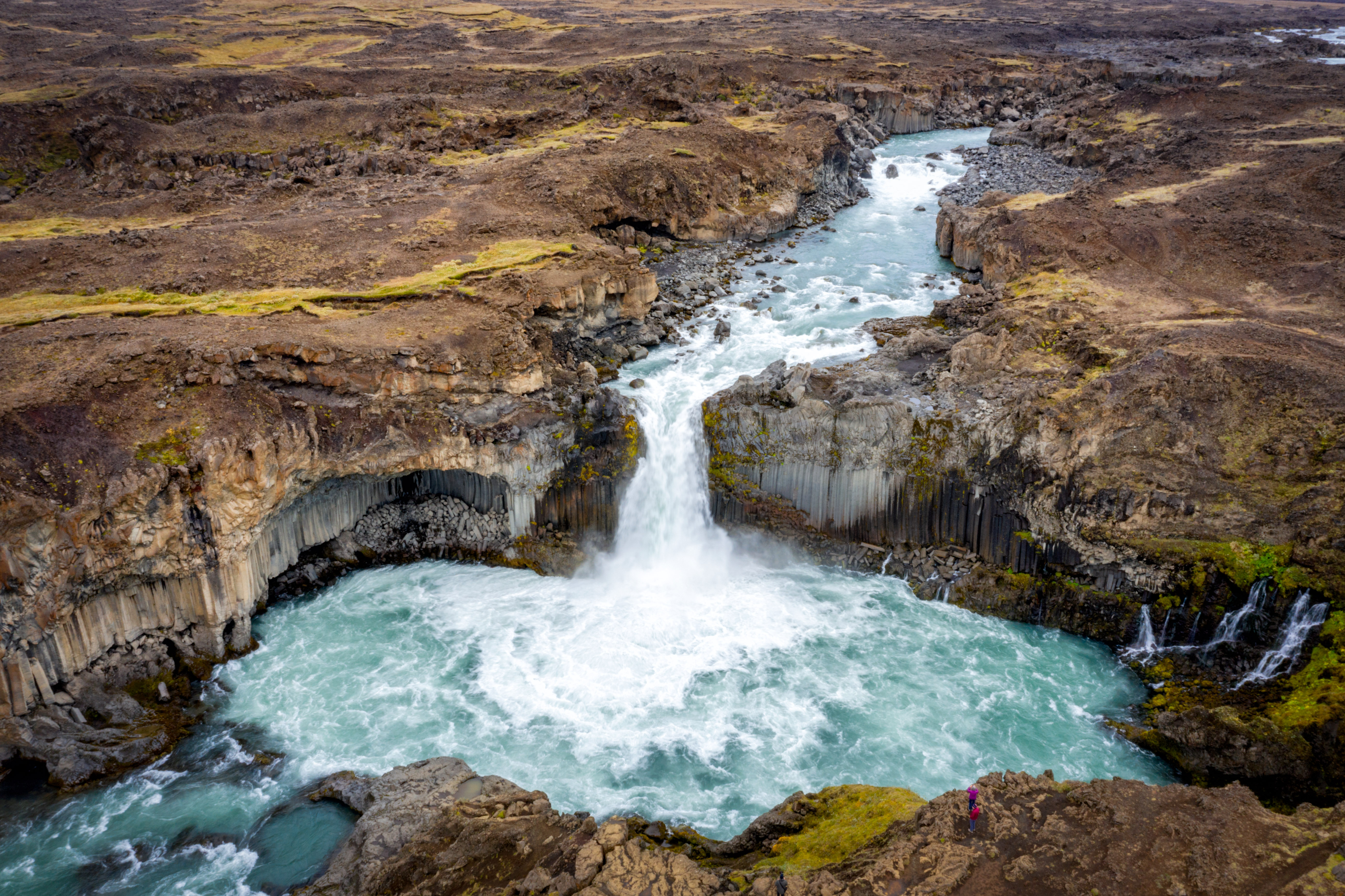 a river running through a canyon with Aldeyjarfoss in the background