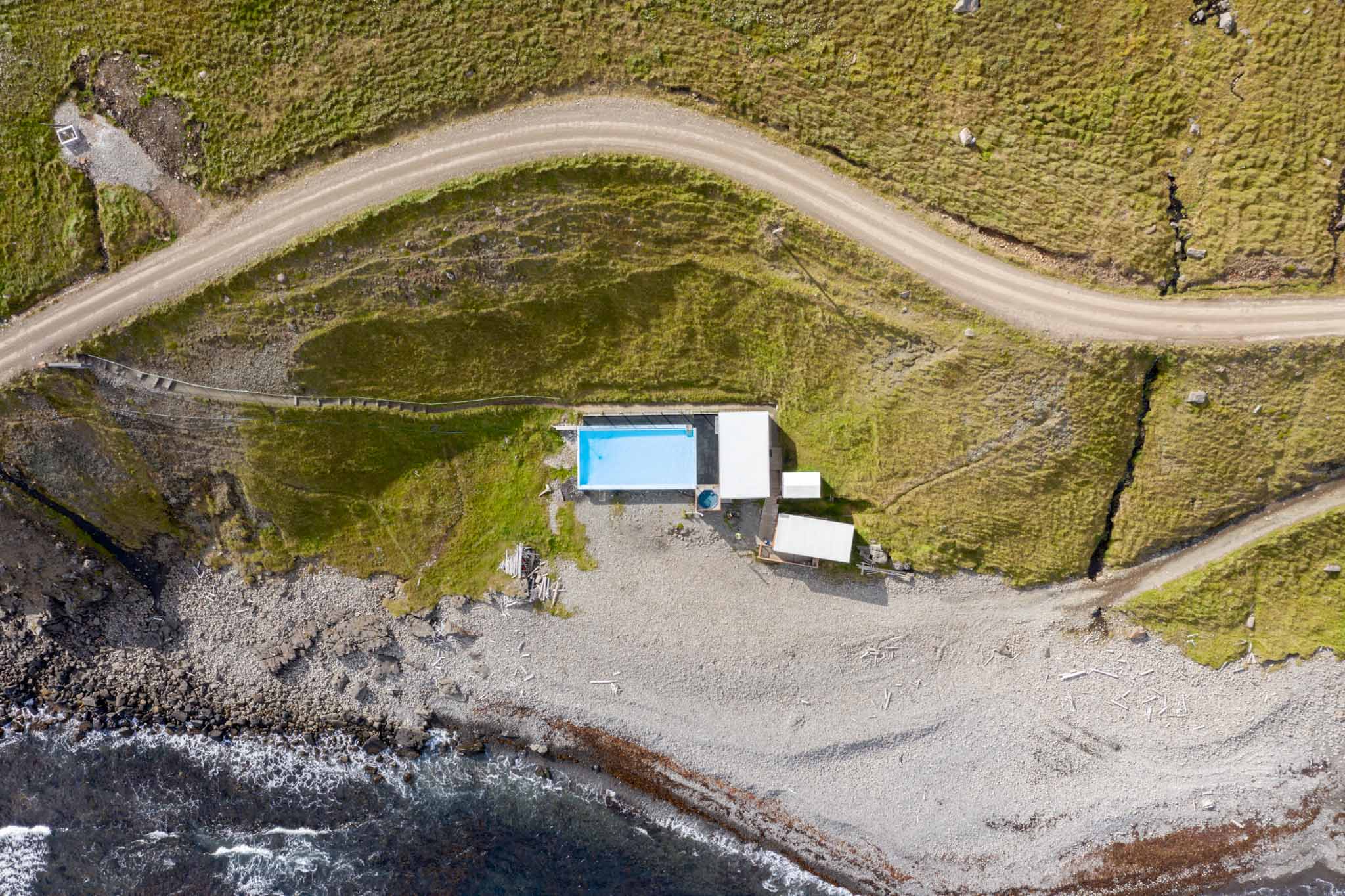 a swimming pool on a rocky beach