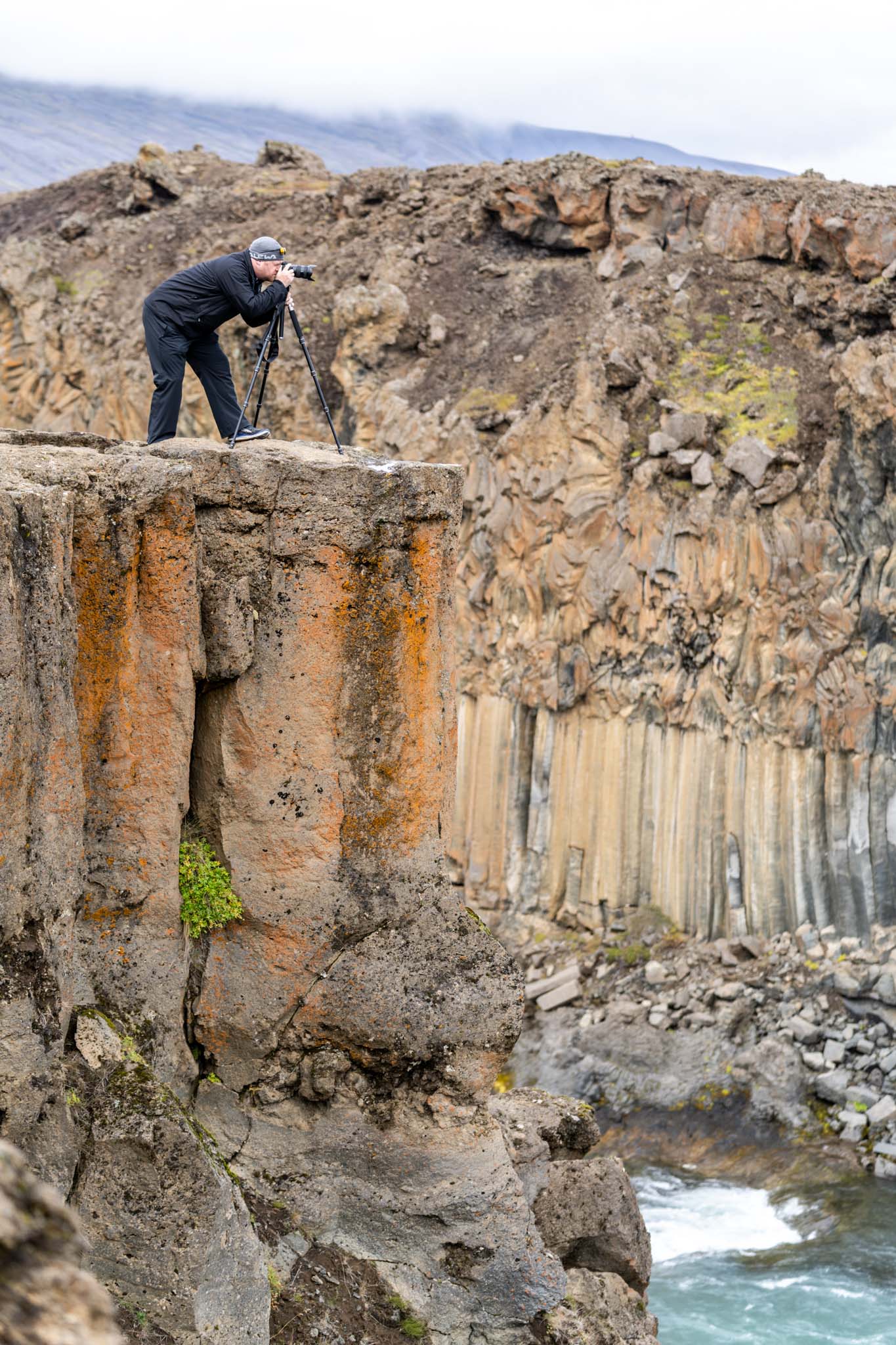 a man taking a picture of a cliff