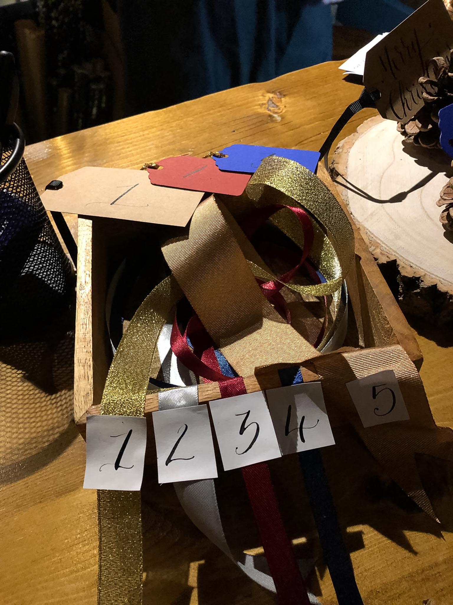 a box of ribbons with tags and numbers