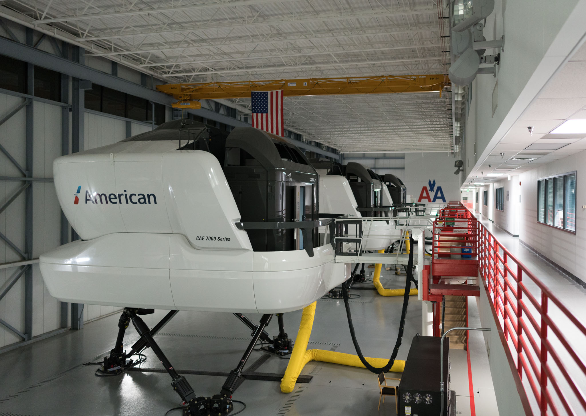a group of helicopters in a hangar