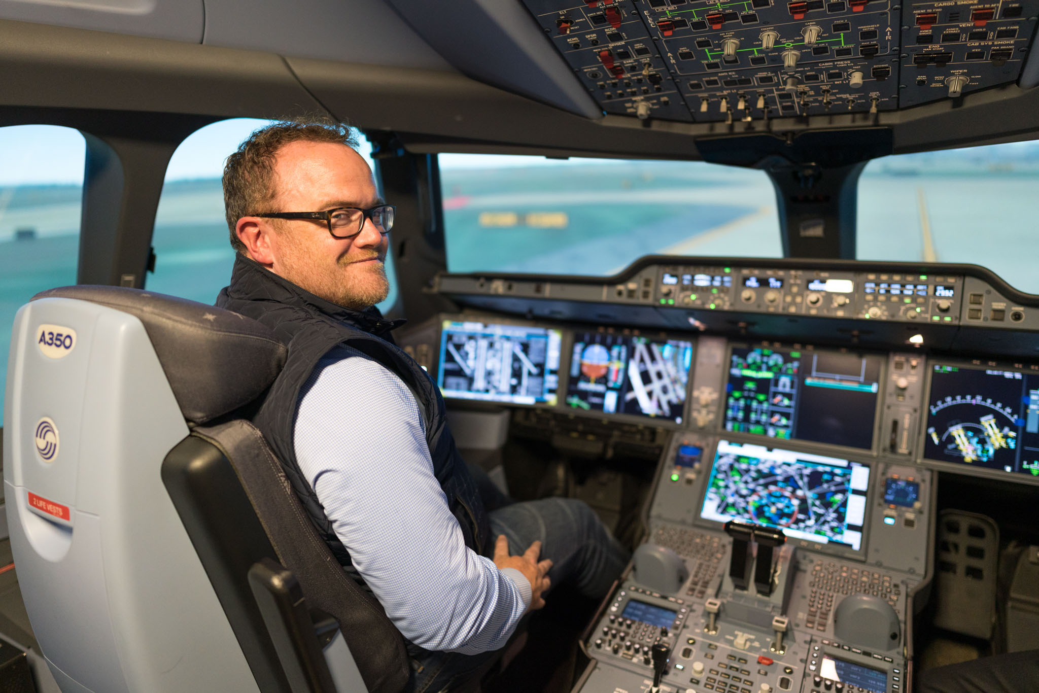 a man sitting in a cockpit of an airplane