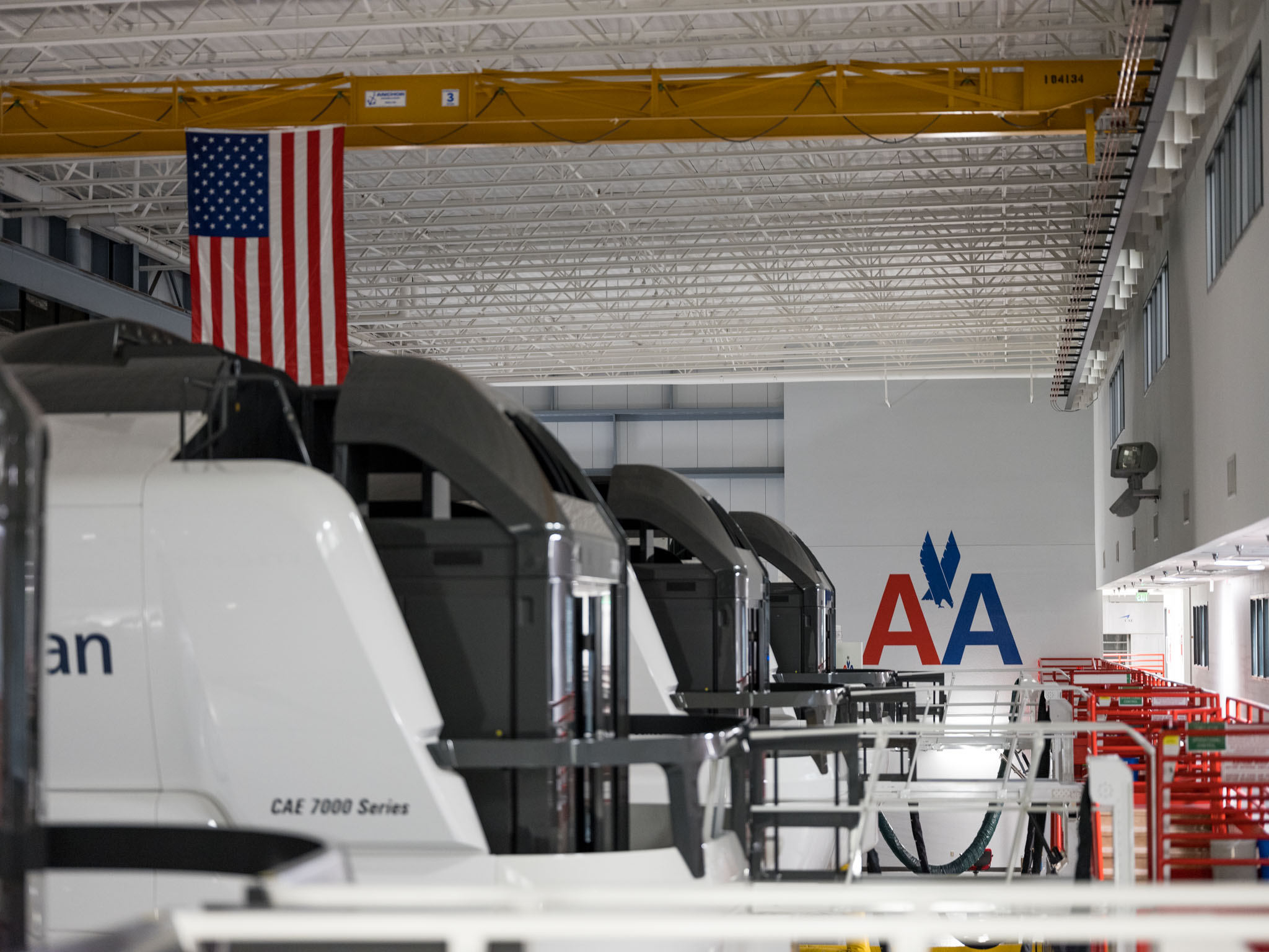 a row of white and black vehicles in a warehouse