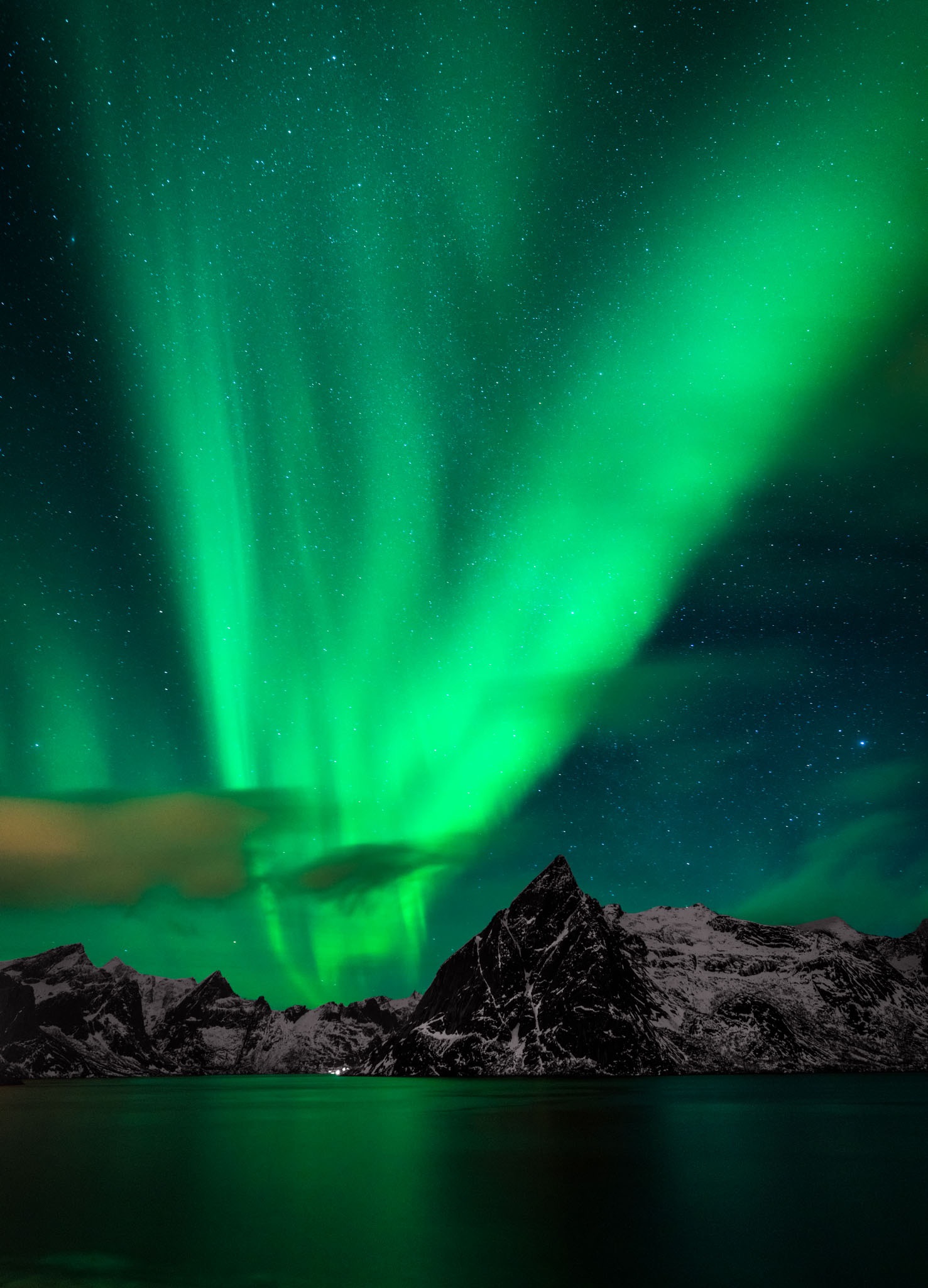 green lights in the sky over mountains