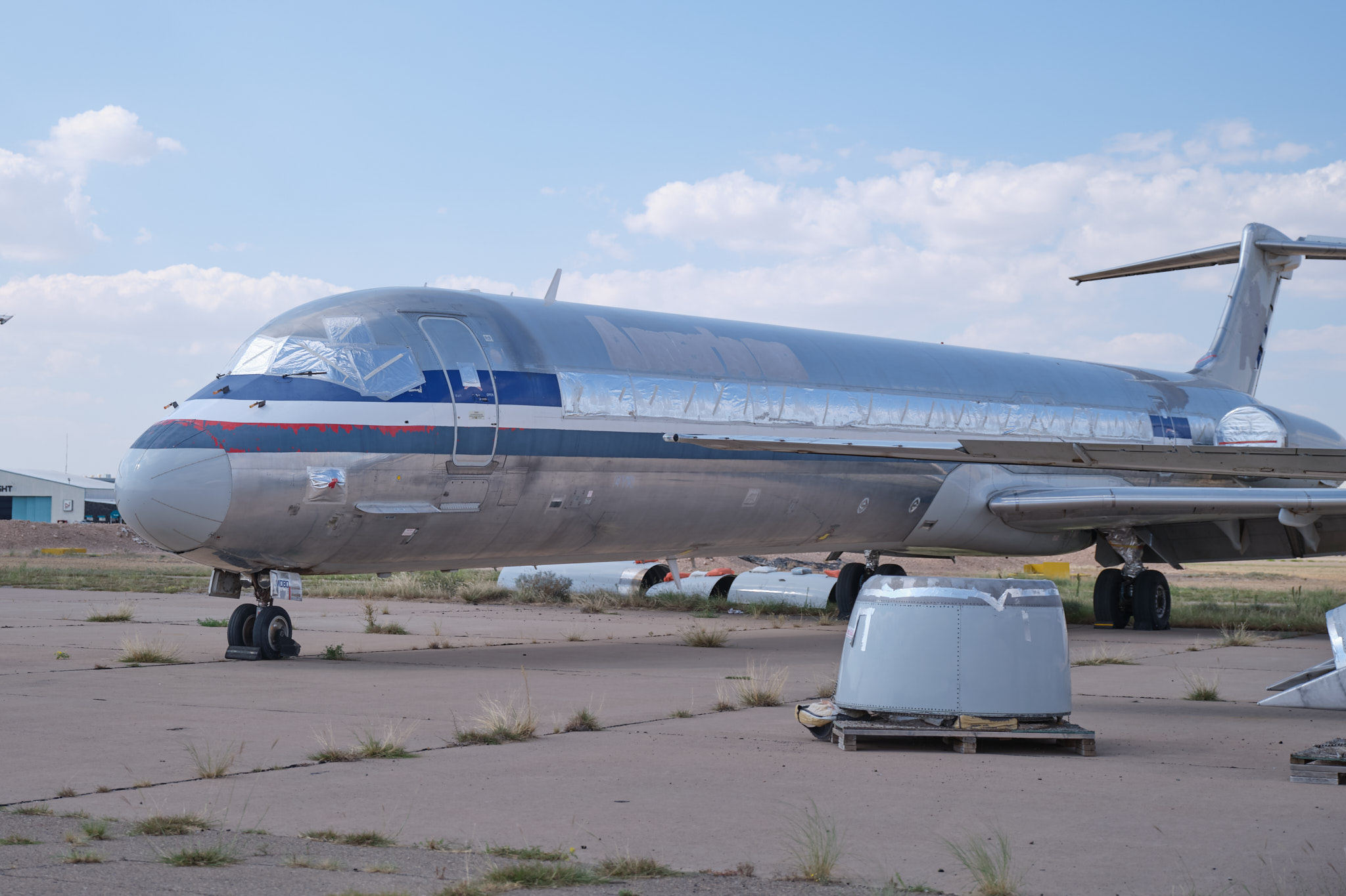 a silver airplane on a tarmac