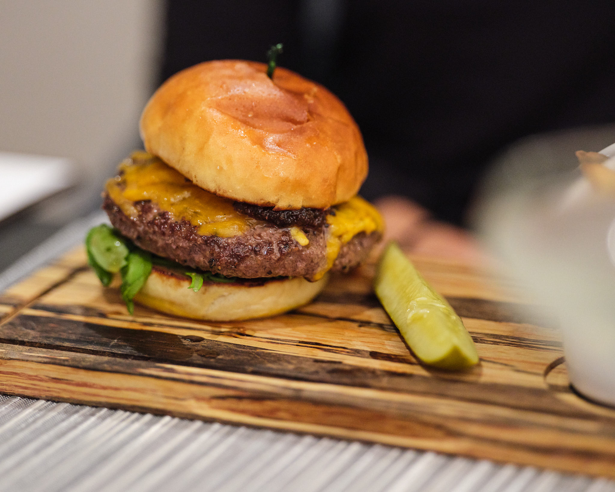 a cheeseburger on a wooden board