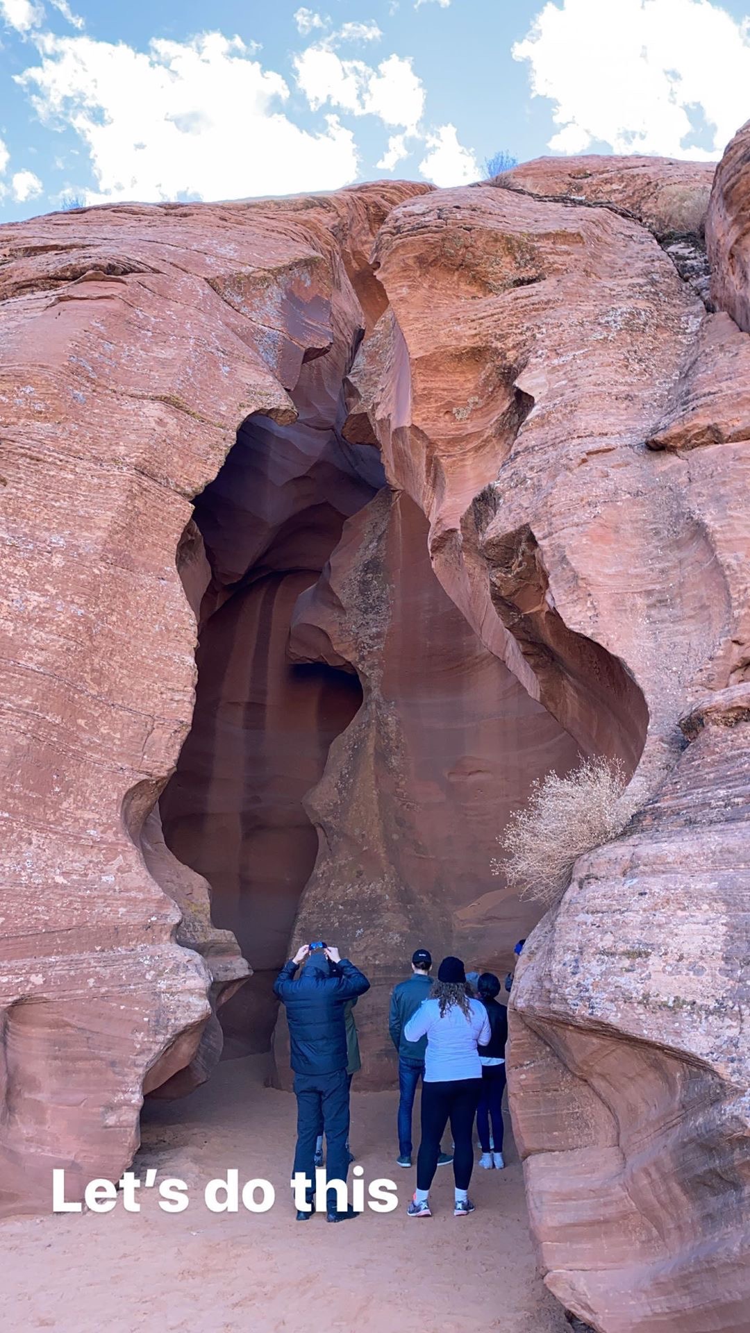 a group of people standing in a cave