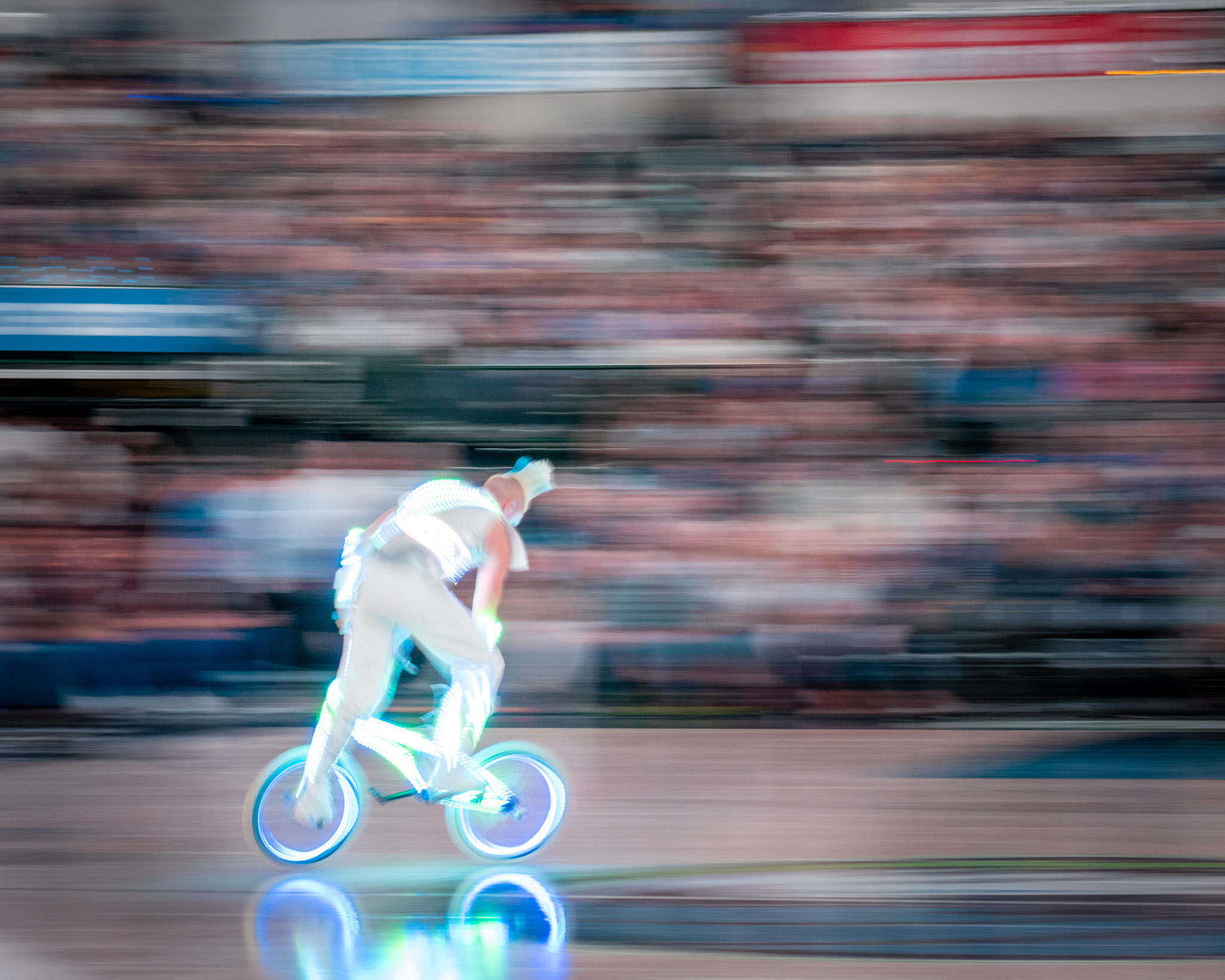 a man riding a bicycle with lights on
