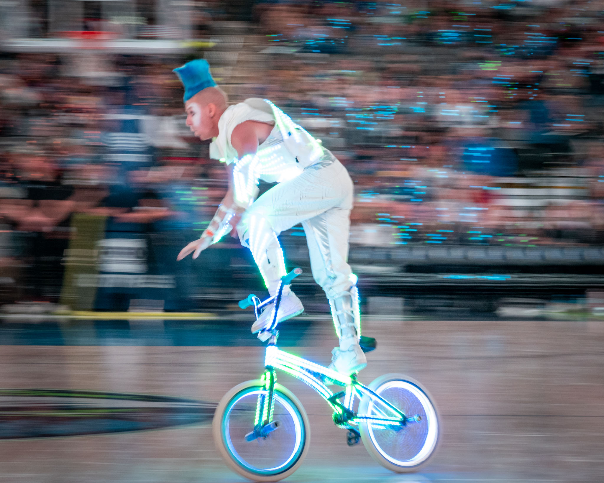a man on a bicycle with lights on
