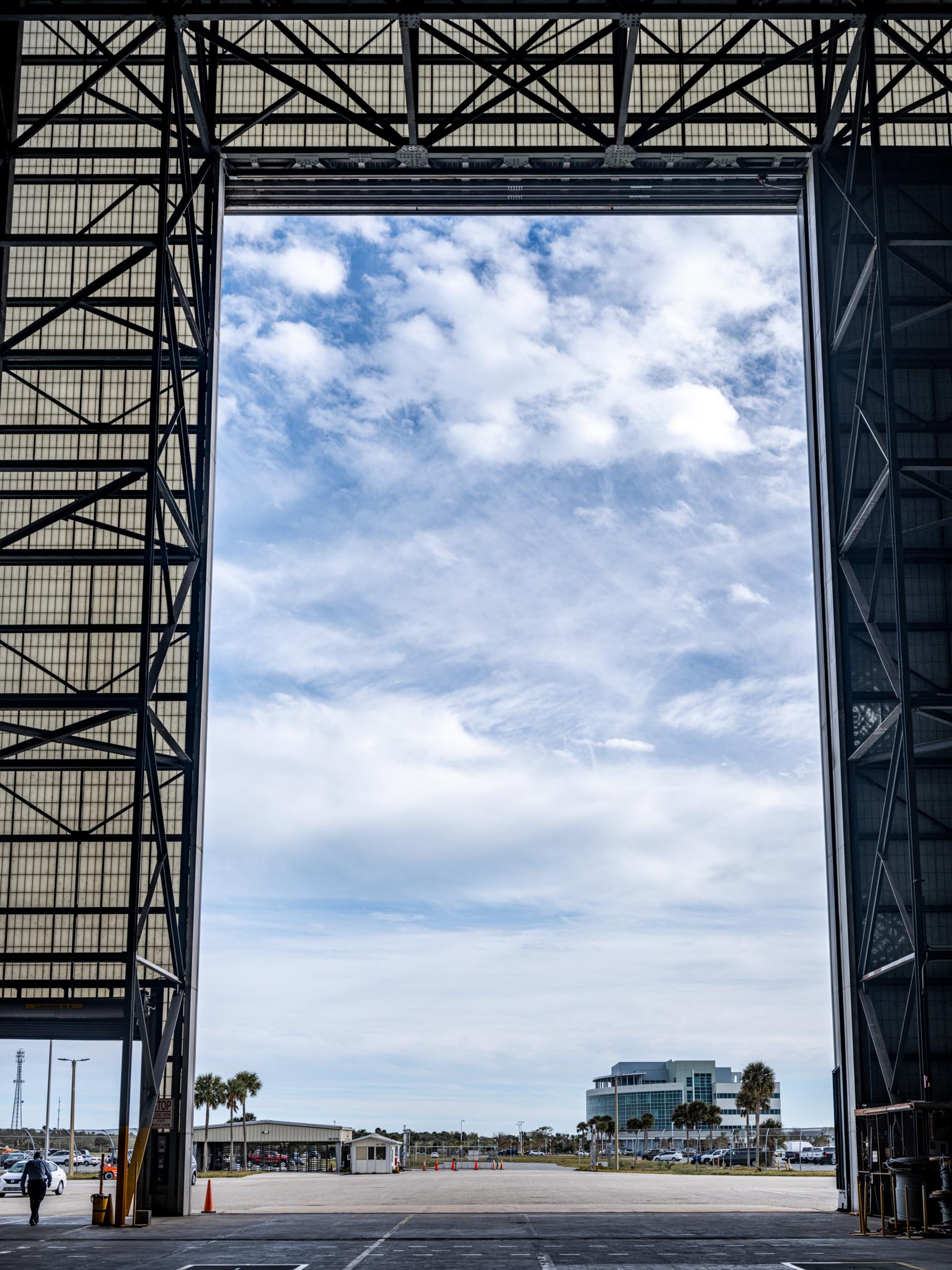 a large rectangular frame with a blue sky and clouds above