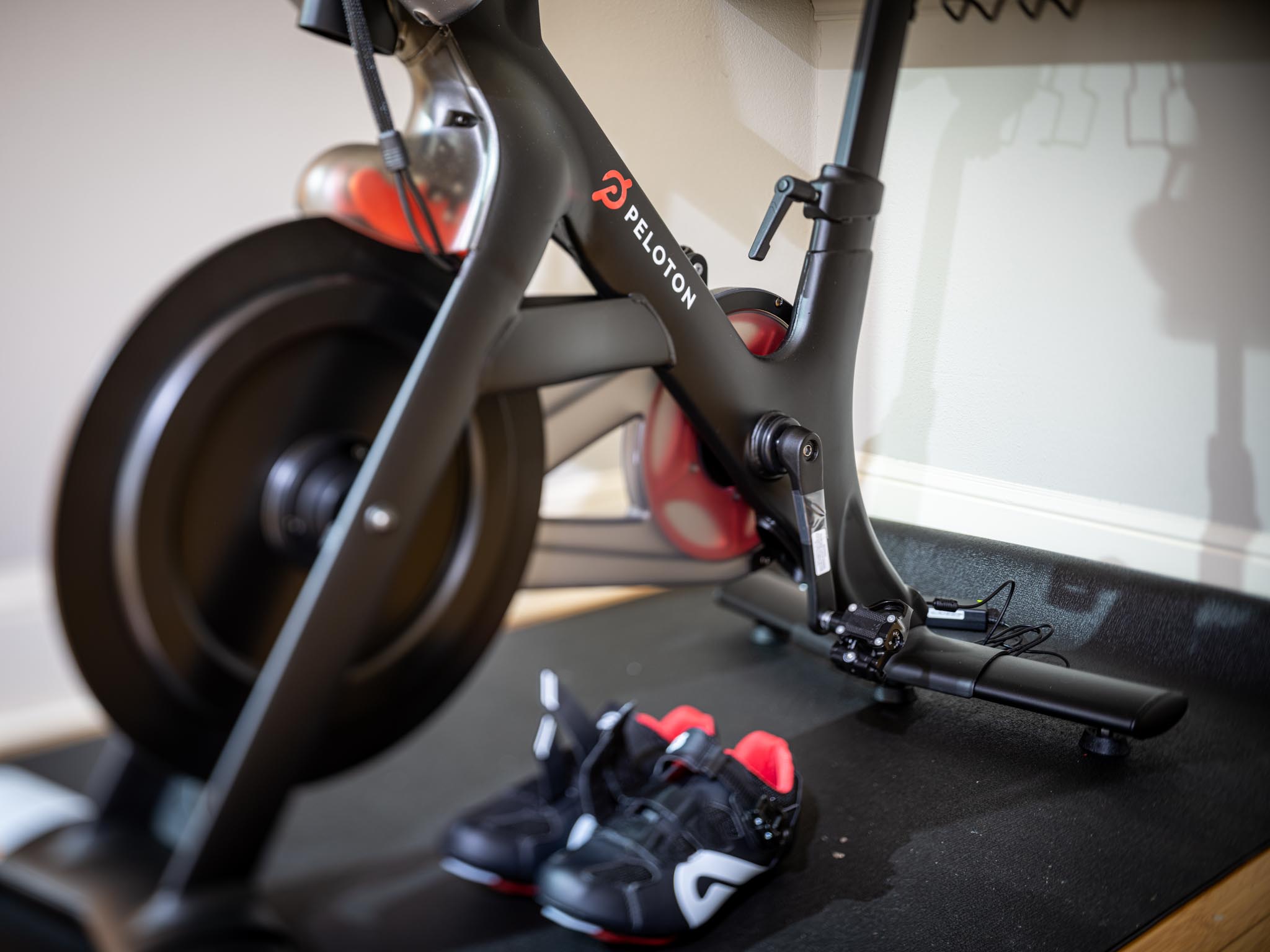 a black exercise bike with shoes on the floor