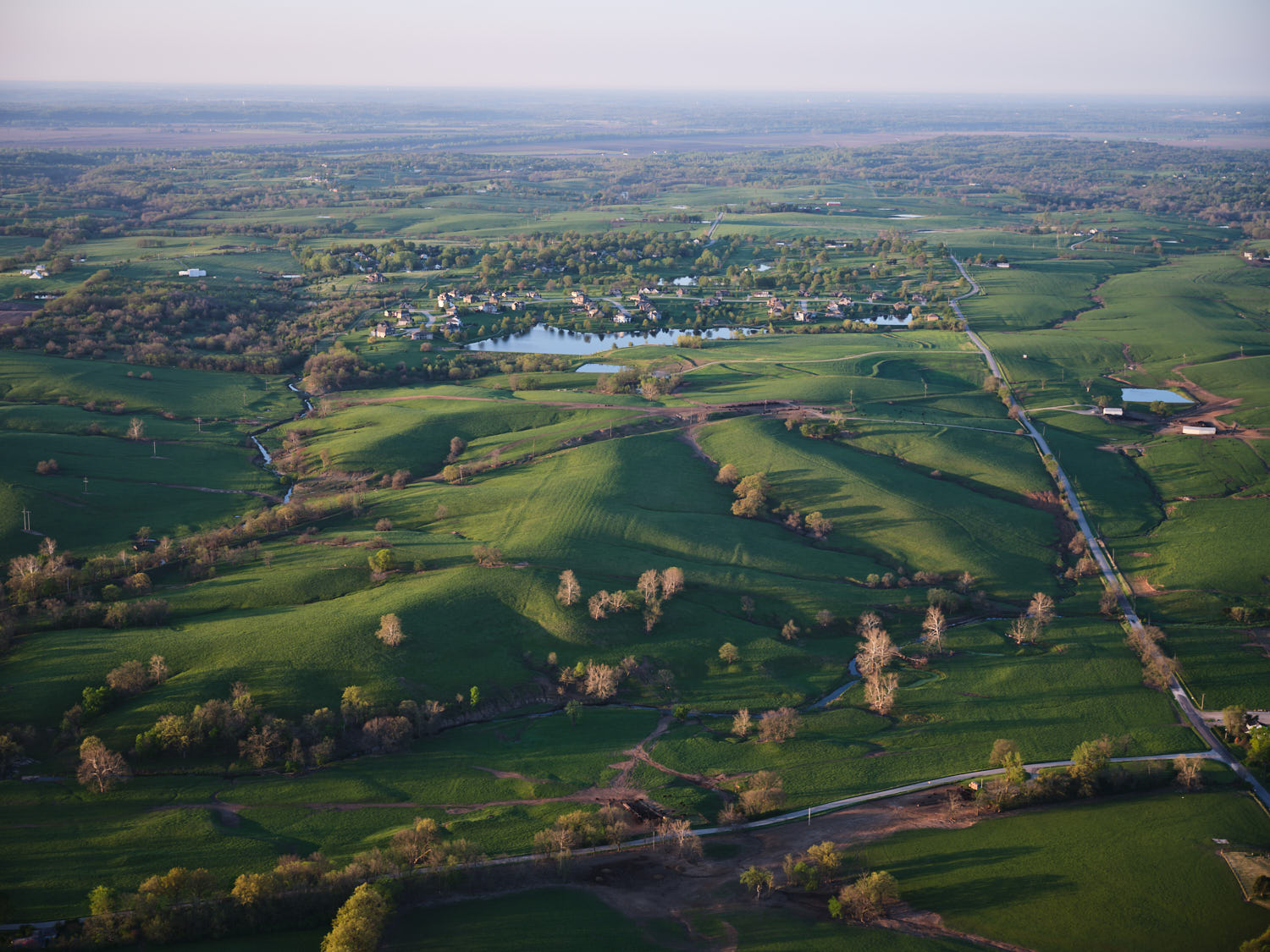 an aerial view of a green landscape