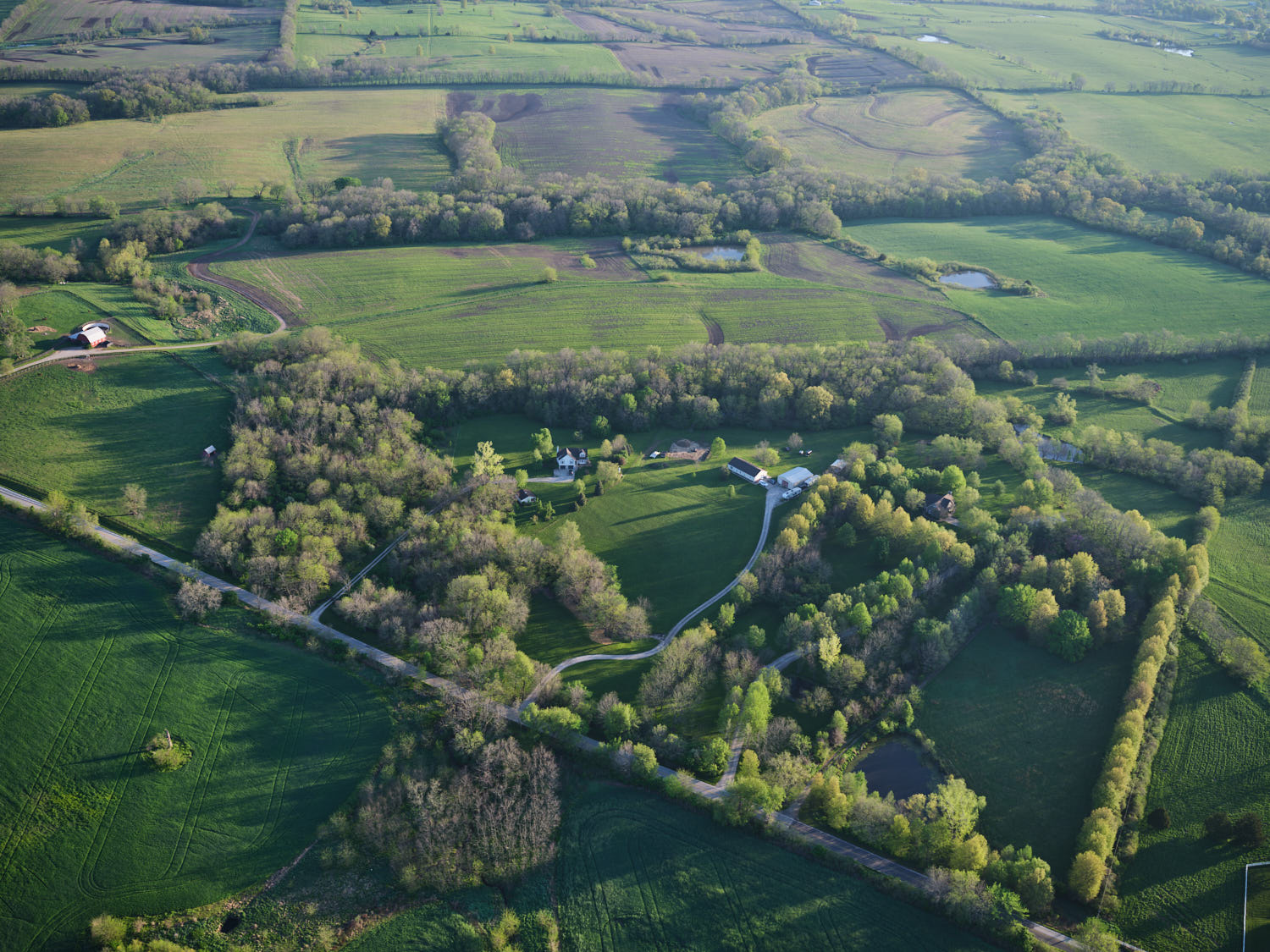 an aerial view of a green landscape